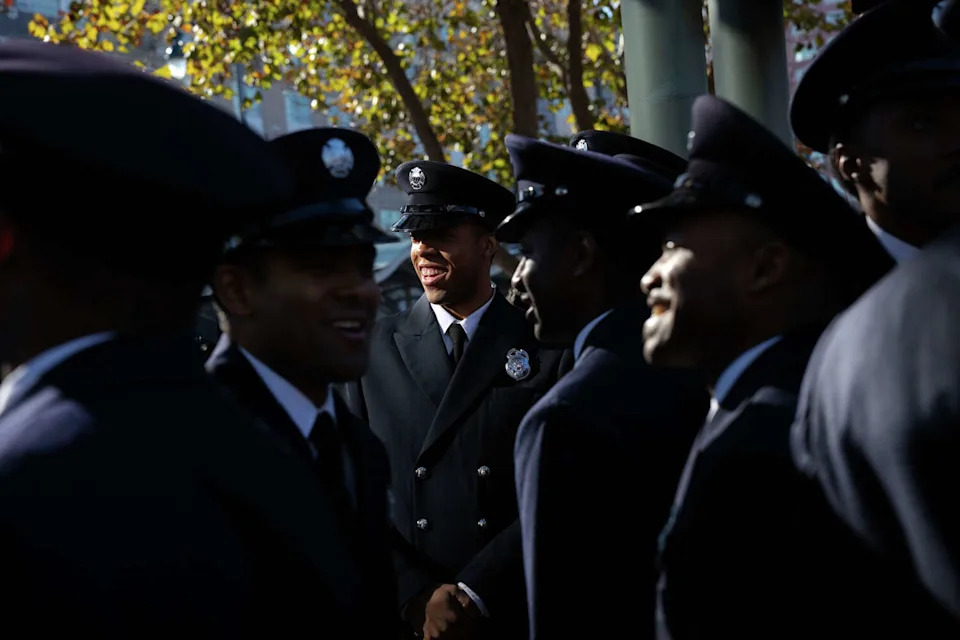 San Francisco firefighter Jordan Hudson, center, chats with his colleagues Monday before marching in San Francisco's annual Martin Luther King, Jr. Day parade. (Manuel Orbegozo/For the S.F. Chronicle)