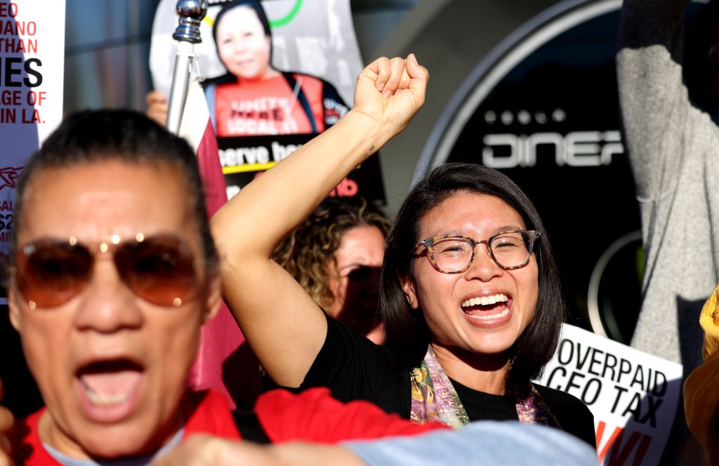 Reverend Rae Huang leading The Fair Games Coalition and labor organizations in support of The Overpaid CEO Tax Initiative.
