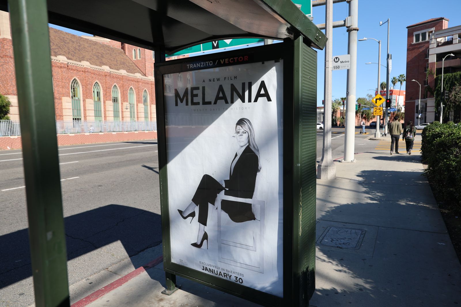 Image may contain Bus Stop Outdoors Advertisement Adult Person Clothing Footwear High Heel Shoe and Car