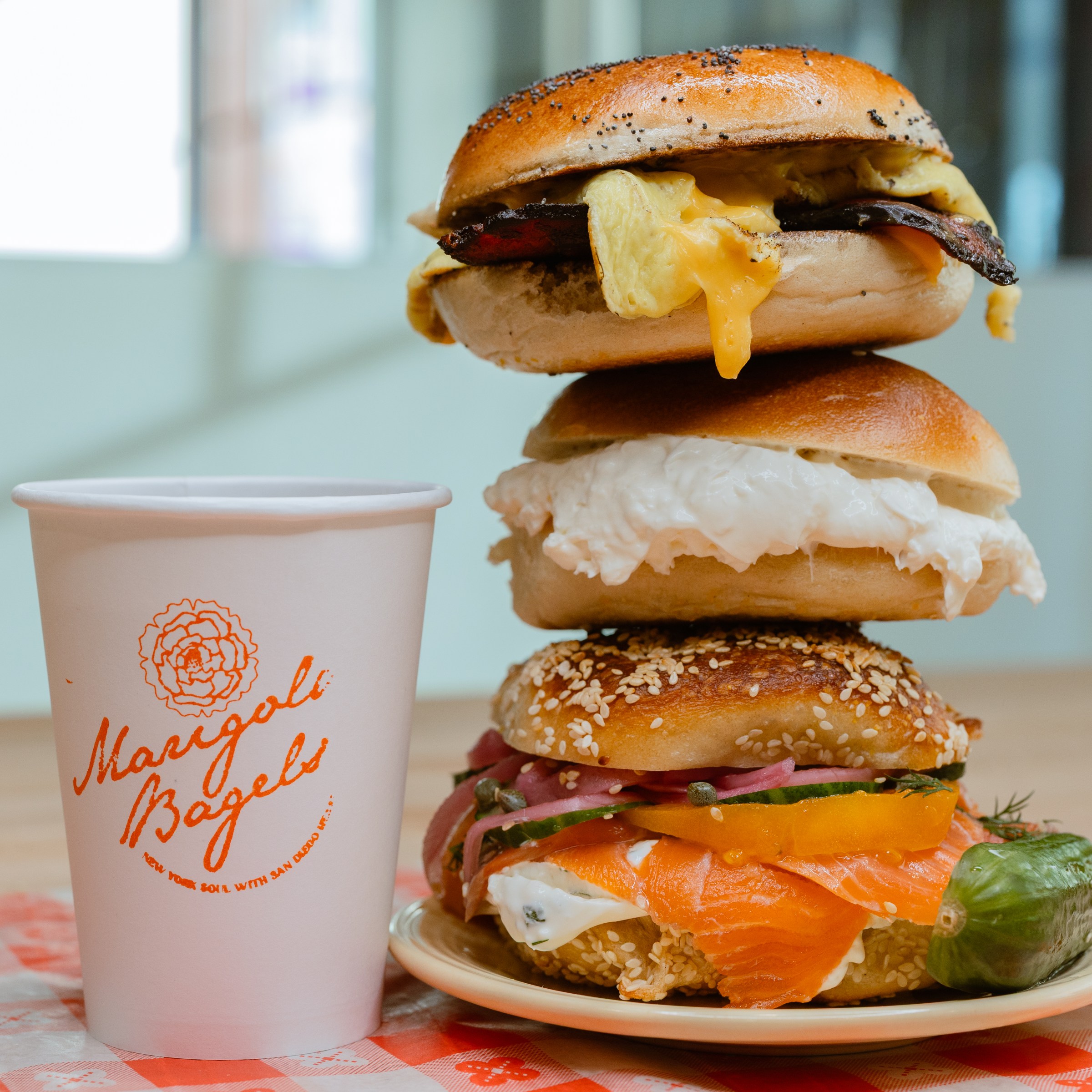 Three stacked breakfast sandwiches from Marigold Bagels.