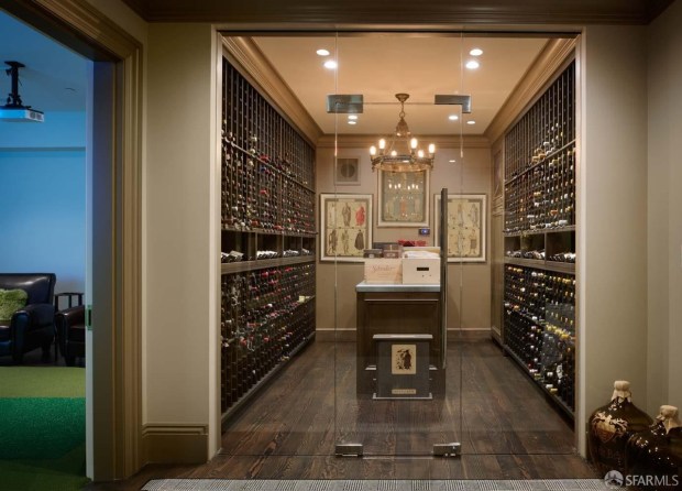 A wine cellar with glass doors.