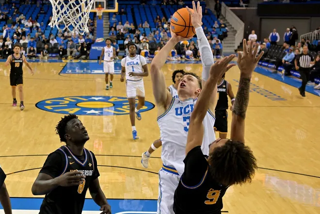 Dec 23, 2025; Los Angeles, California, USA; UCLA Bruins forward Tyler Bilodeau (34) shoots over UC Riverside Highlanders forward BJ Kolly (8) and forward Osiris Grady (9) in the first half at Pauley Pavilion presented by Wescom Financial.