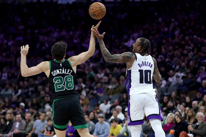 Jan 1, 2026; Sacramento, California, USA; Boston Celtics forward Hugo Gonzalez (28) and Sacramento Kings forward DeMar DeRozan (10) battles for the rebound during the fourth quarter at Golden 1 Center. Mandatory Credit: Dennis Lee-Imagn Images