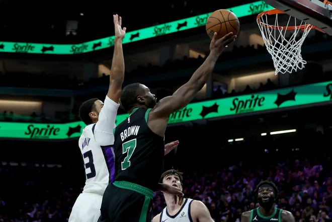 Jan 1, 2026; Sacramento, California, USA; Boston Celtics forward Jaylen Brown (7) goes up for a basket while defended by Sacramento Kings forward Keegan Murray (13) during the second quarter at Golden 1 Center. Mandatory Credit: Dennis Lee-Imagn Images