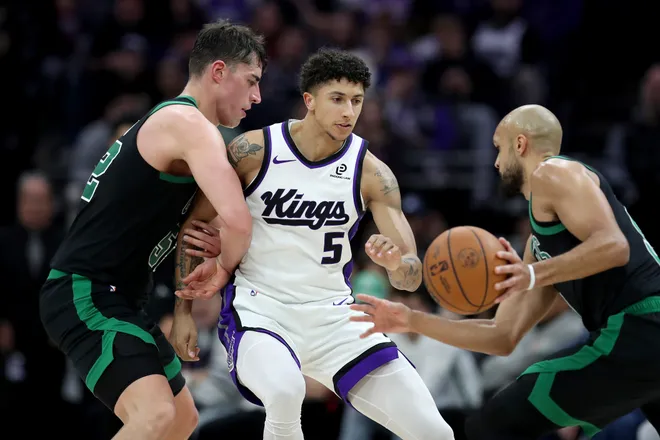 Jan 1, 2026; Sacramento, California, USA; Boston Celtics forward Luka Garza (52) sets a screen on Sacramento Kings guard Nique Clifford (5) during the fourth quarter at Golden 1 Center. Mandatory Credit: Dennis Lee-Imagn Images