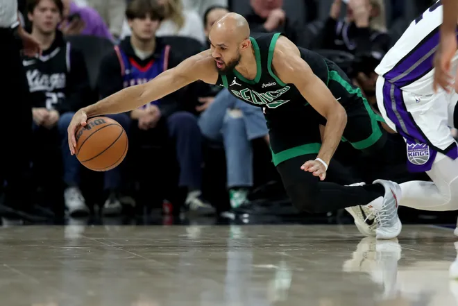 Jan 1, 2026; Sacramento, California, USA; Boston Celtics guard Derrick White (9) dives for a loose ball against the Sacramento Kings during the second quarter at Golden 1 Center. Mandatory Credit: Dennis Lee-Imagn Images