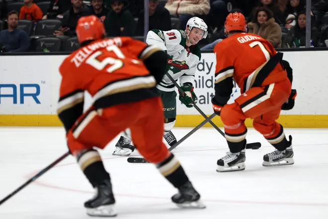 Jan 2, 2026; Anaheim, California, USA; Anaheim Ducks center Leo Carlsson (91) looks to pass the puck against Anaheim Ducks defenseman Radko Gudas (7) during the third period at Honda Center.