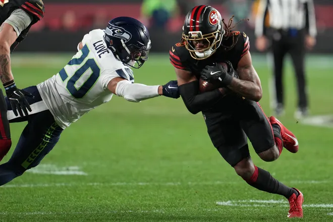 Jan 3, 2026; Santa Clara, California, USA; San Francisco 49ers wide receiver Demarcus Robinson (5) makes catch against Seattle Seahawks safety Julian Love (20) during the second half at Levi's Stadium. Mandatory Credit: Neville E. Guard-Imagn Images