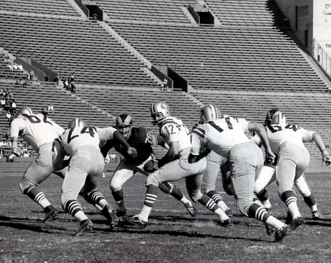 San Francisco 49ers quarterback John Brodie (12) turns to handoff to Billy Kilmer (17) against the Los Angeles Rams at Memorial Coliseum.