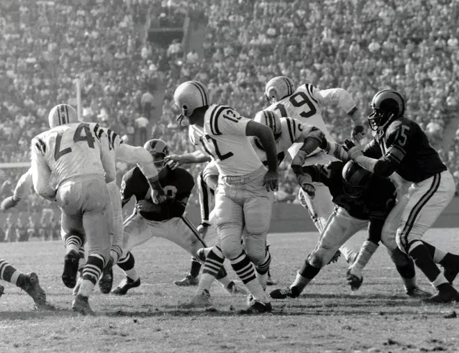 John Brodie hands the ball off to running back J.D. Smith (24) during the 1961 season.