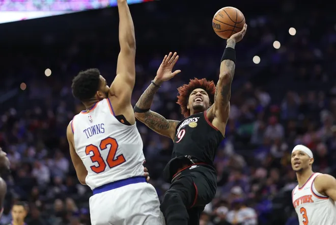 Jan 24, 2026; Philadelphia, Pennsylvania, USA; Philadelphia 76ers guard Kelly Oubre Jr. (9) shoots in front of New York Knicks center Karl-Anthony Towns (32) during the third quarter at Xfinity Mobile Arena.