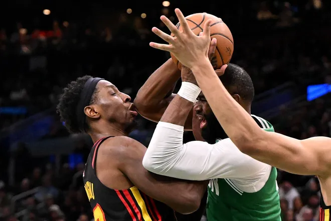 Jan 28, 2026; Boston, Massachusetts, USA; Atlanta Hawks forward Onyeka Okongwu (17) reacts after being hit in the jaw with an elbow by Boston Celtics guard Jaylen Brown (7) during the second half at the TD Garden.