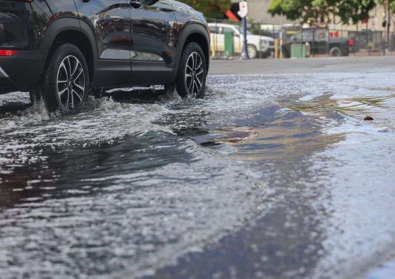 A car drives through a flooded road on the morning of Sunday, Jan. 26, 2025.