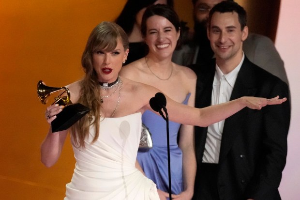 Taylor Swift accepts the Album of the Year trophy for "Midnights" during the 66th annual Grammy Awards on Sunday, Feb. 4, 2024, in Los Angeles. (AP Photo/Chris Pizzello)