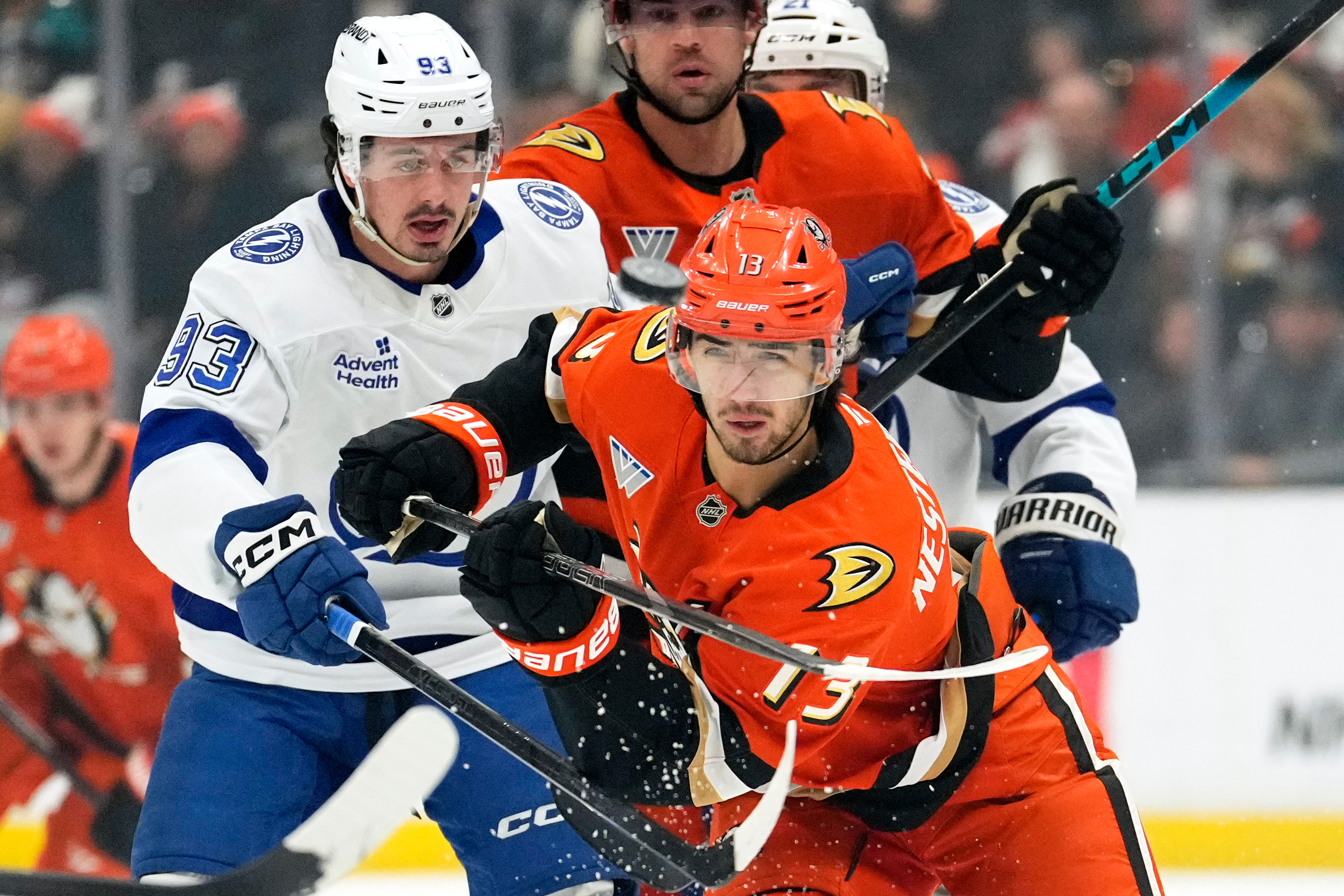 Ducks center Nikita Nesterenko, right, flips the puck in the...