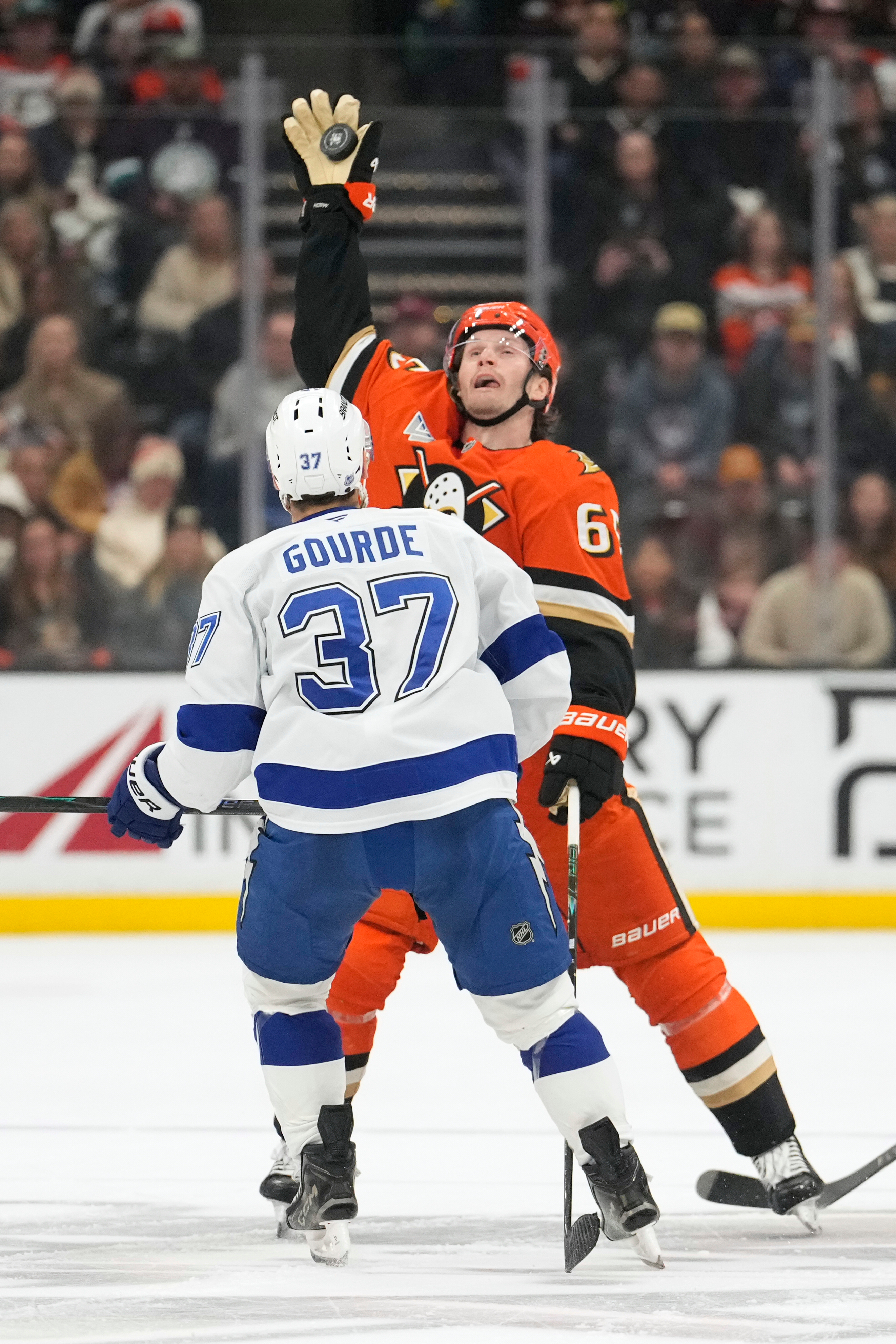 Ducks defenseman Jacob Trouba, right, grabs a puck out of...