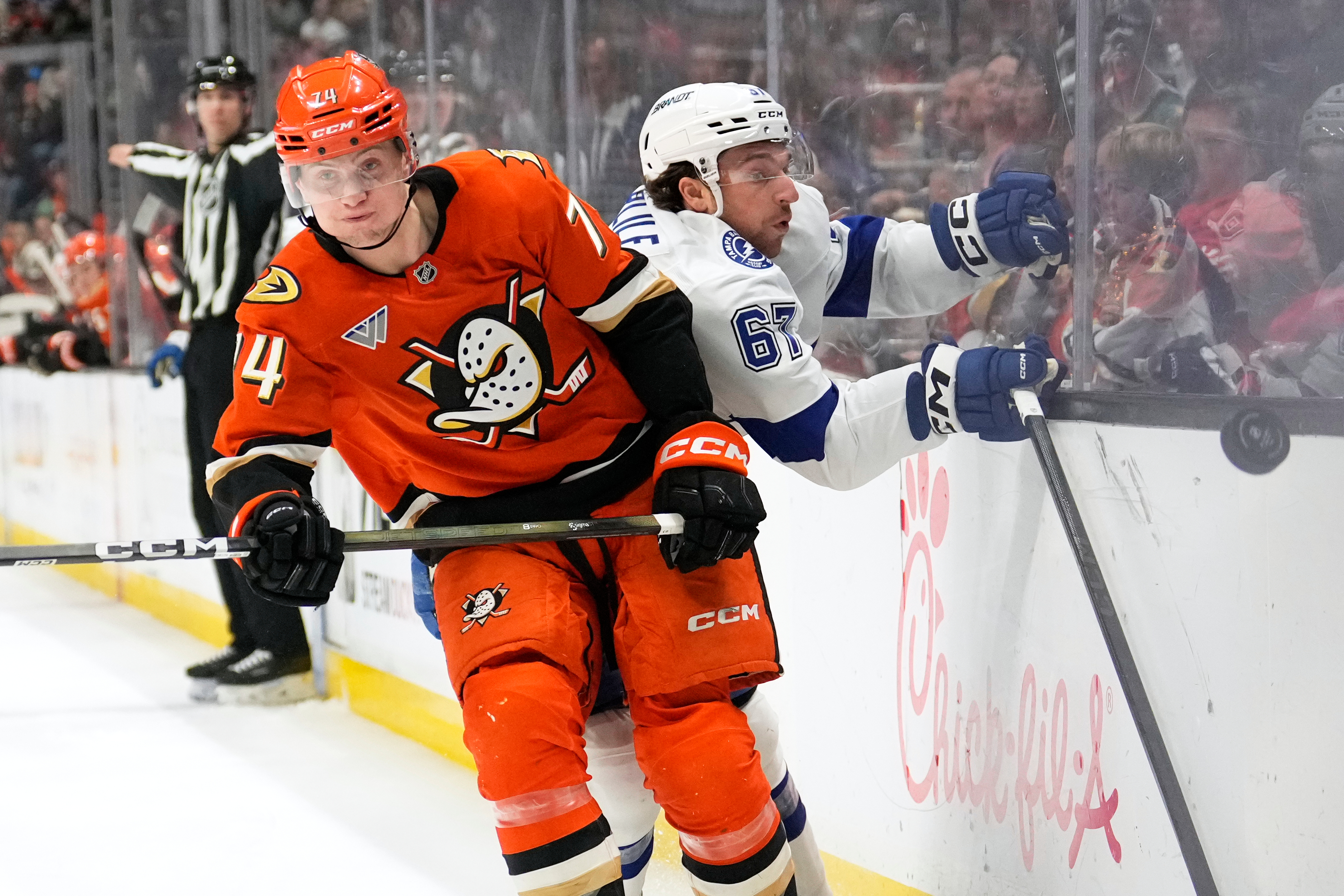 Ducks defenseman Ian Moore, left, puts Tampa Bay Lightning defenseman...