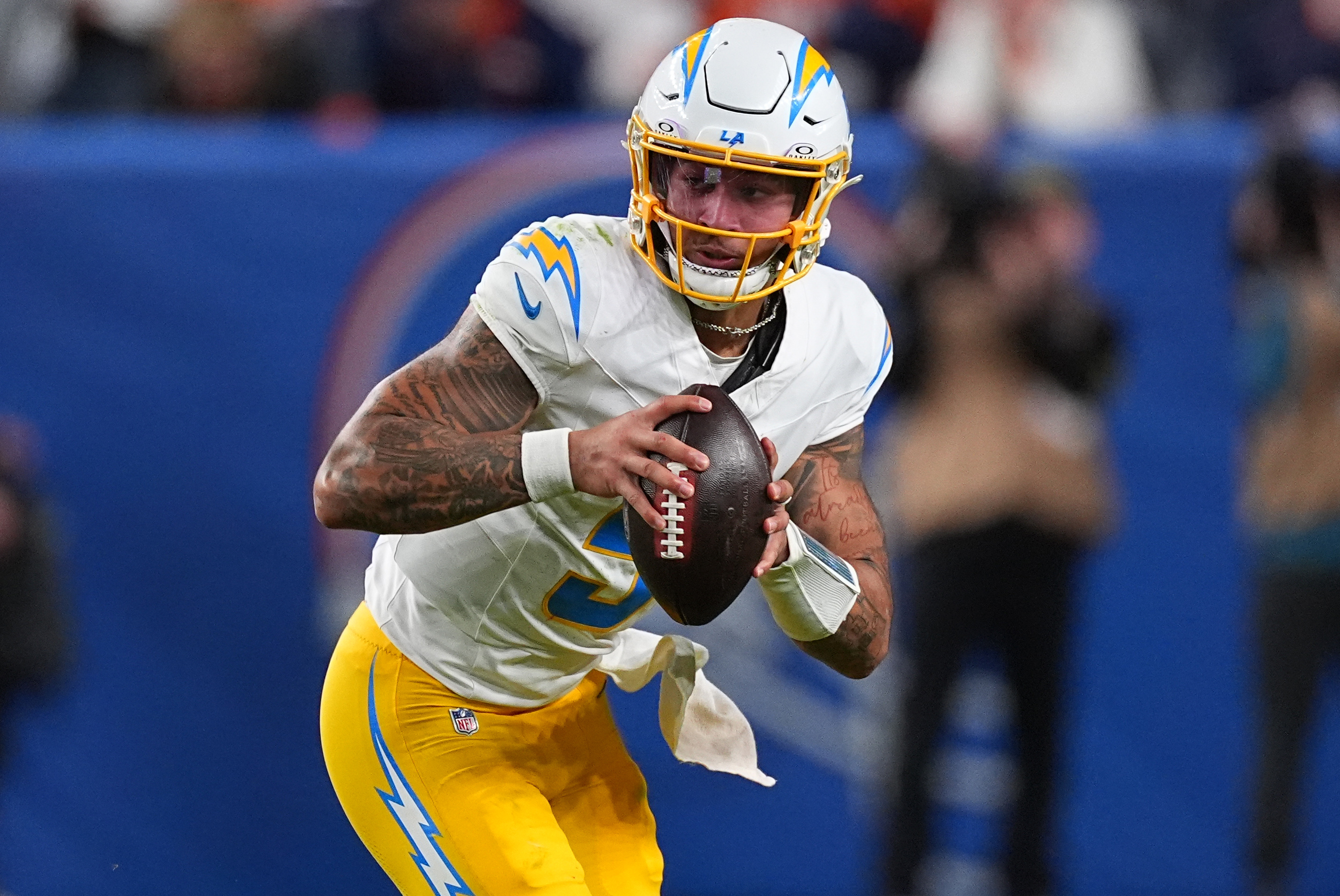 Chargers quarterback Trey Lance (5) runs against the Denver Broncos...