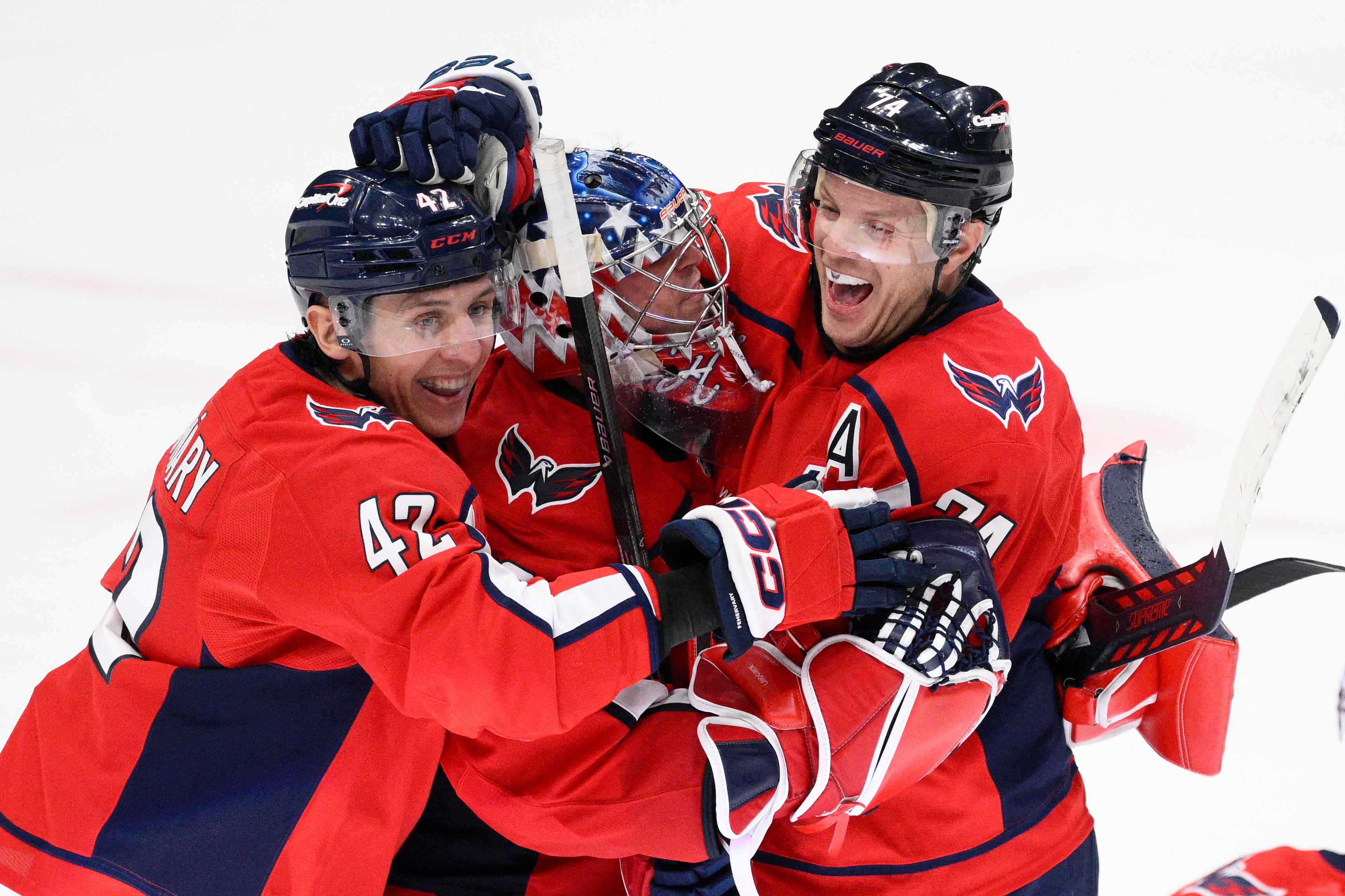 Washington Capitals defenseman John Carlson (74) celebrates with goaltender Charlie...