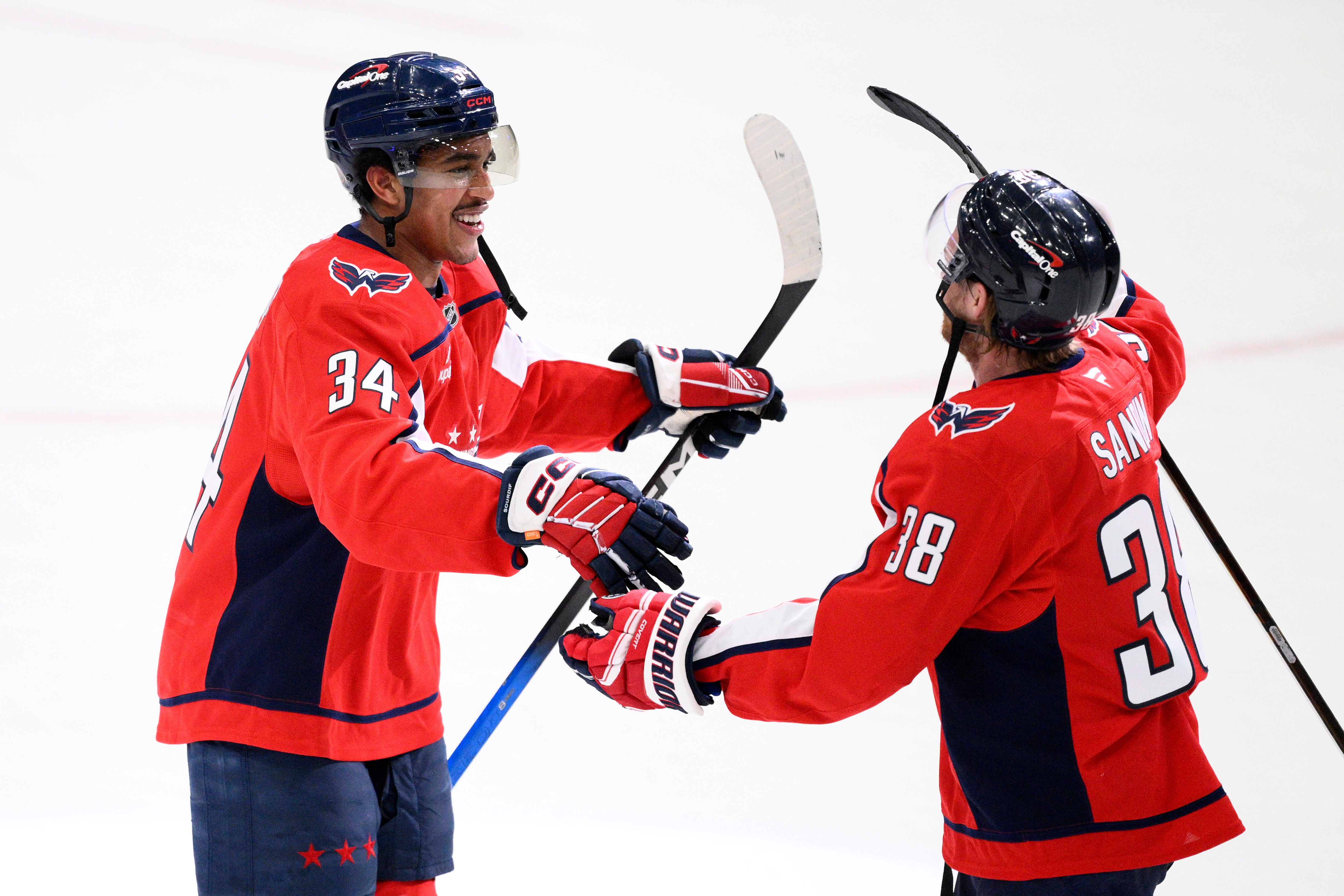 Washington Capitals right wing Justin Sourdif, left, celebrates with defenseman...