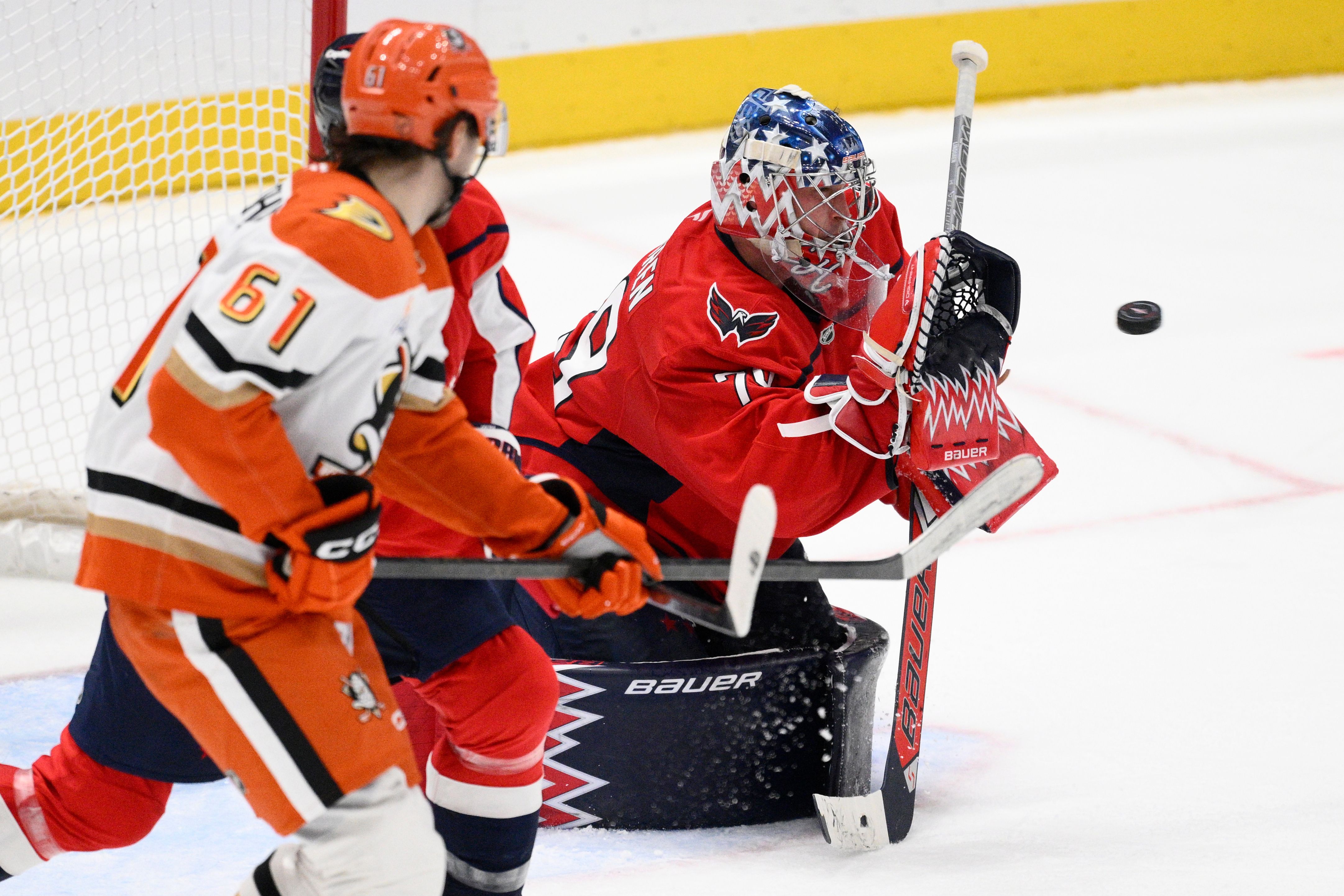 Washington Capitals goaltender Charlie Lindgren, right, stops the puck near...