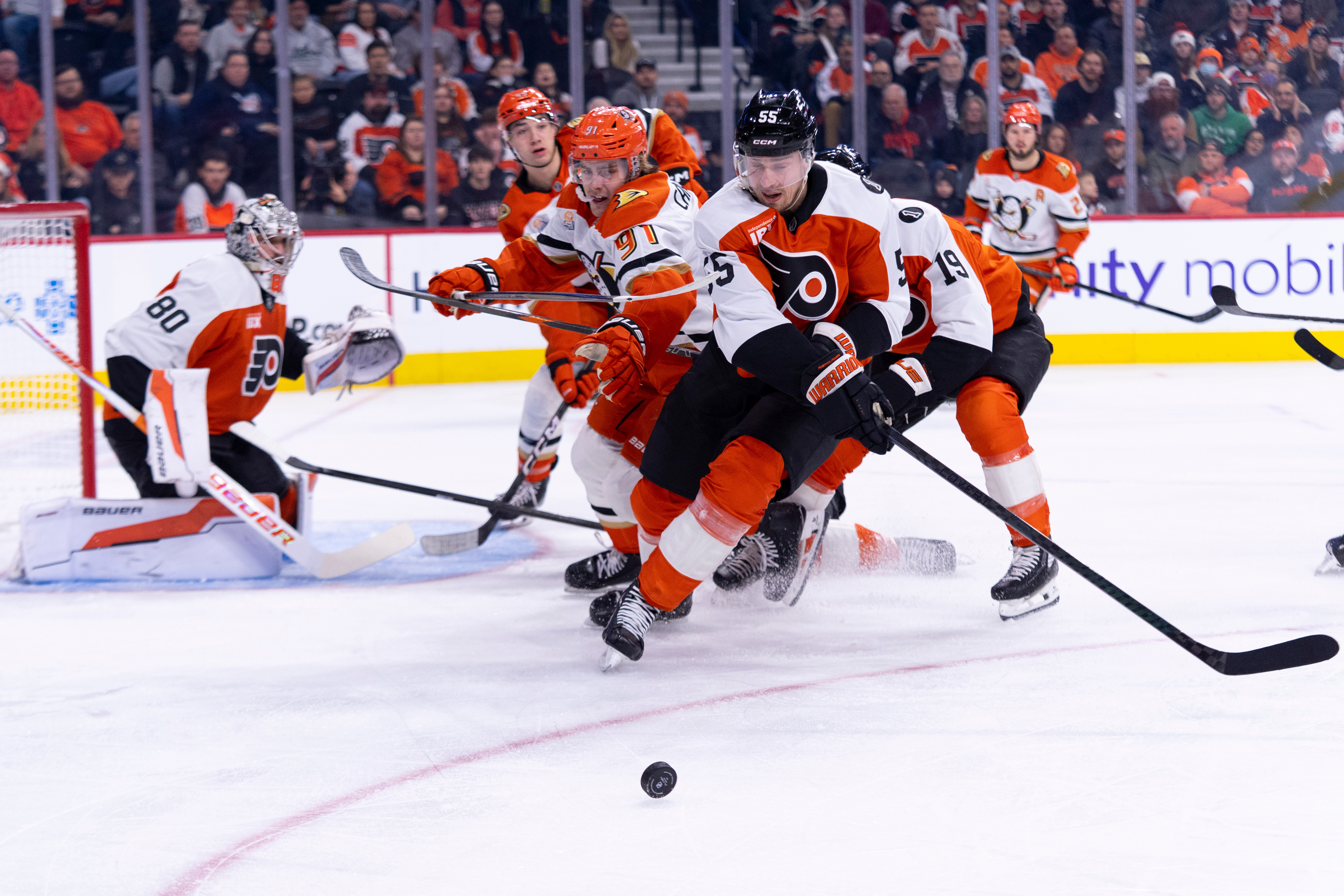 The Philadelphia Flyers’ Rasmus Ristolainen, right, knocks the puck away...
