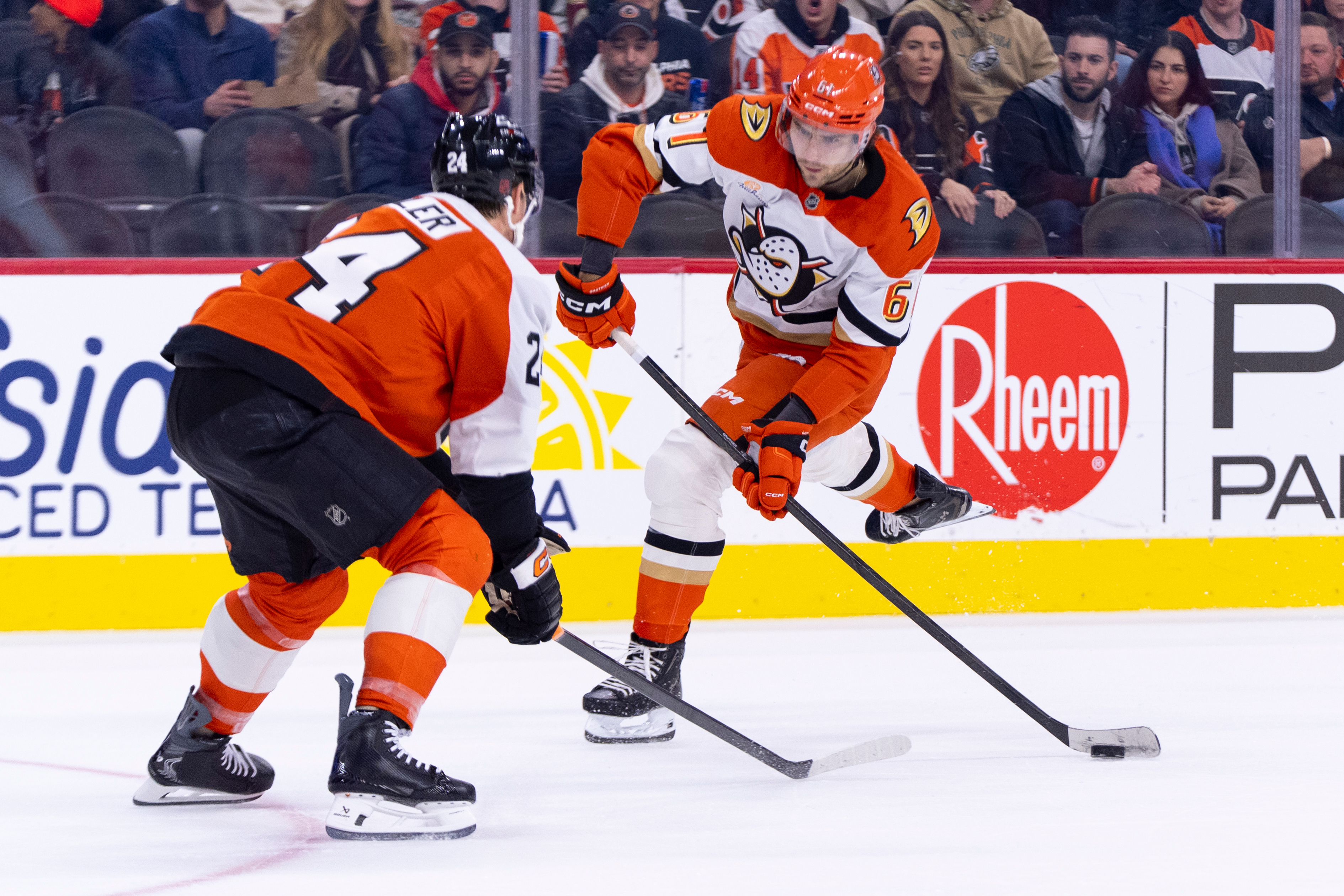The Ducks’ Cutter Gauthier, right, shoots the puck against Philadelphia...