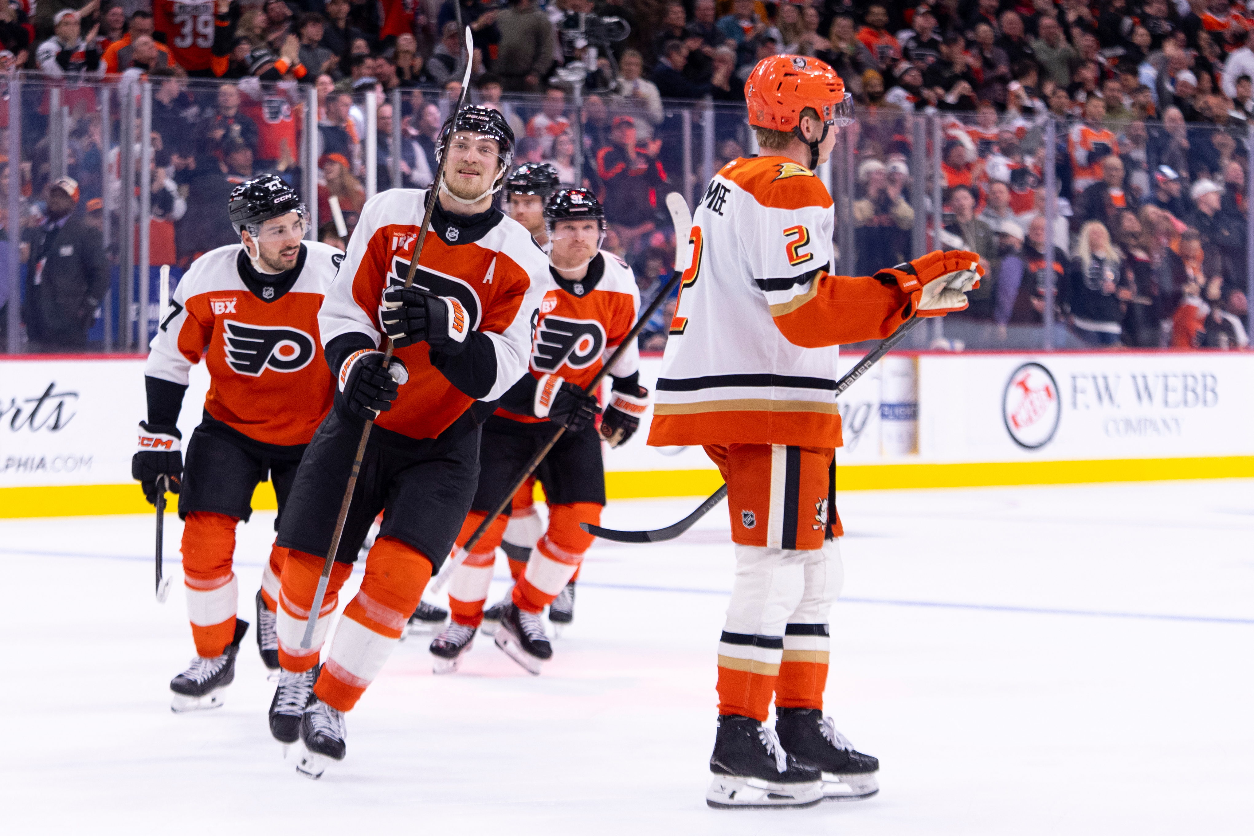 The Philadelphia Flyers’ Travis Sanheim, second from left, celebrates his...