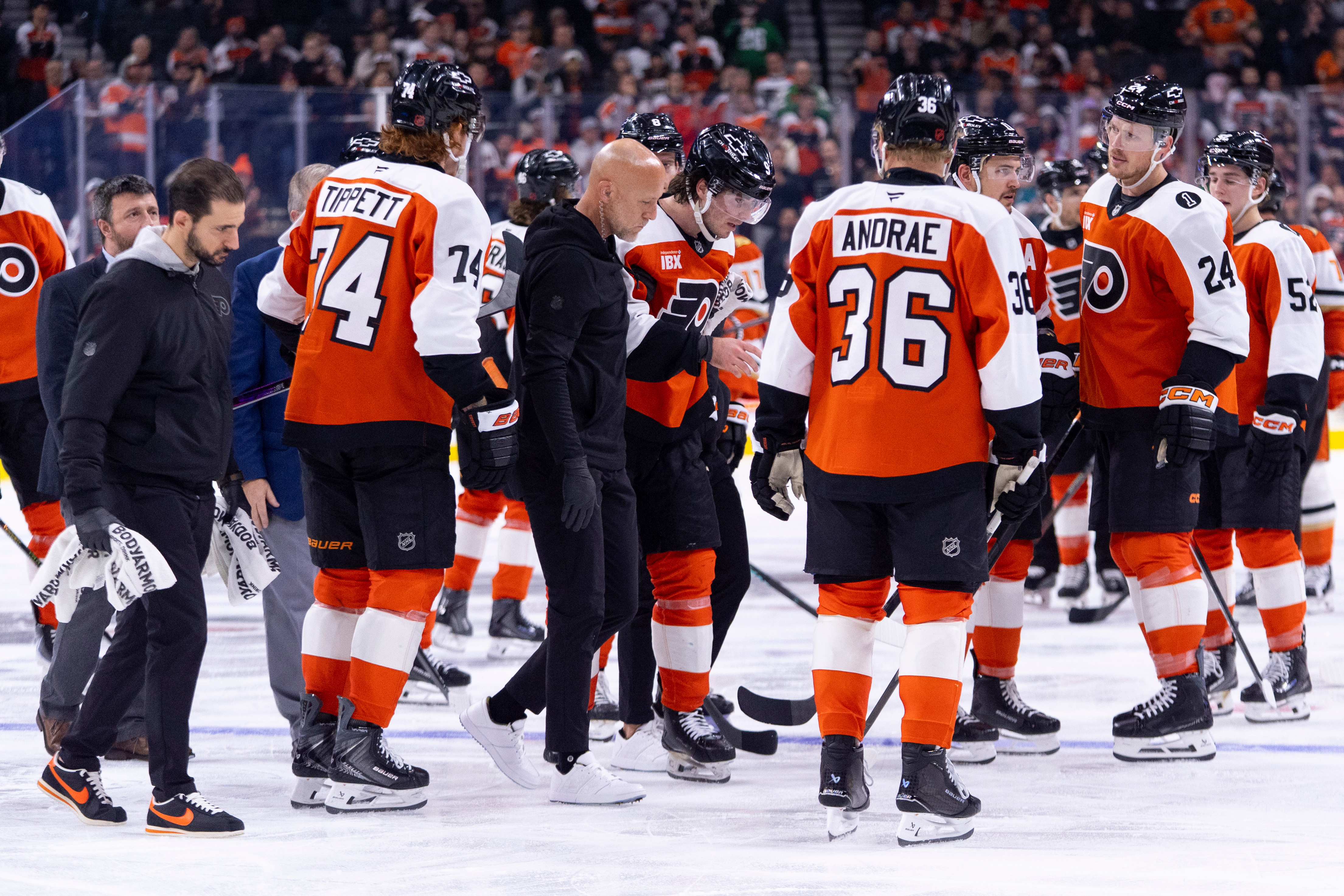 The Philadelphia Flyers’ Jamie Drysdale, center, gets helped off the...