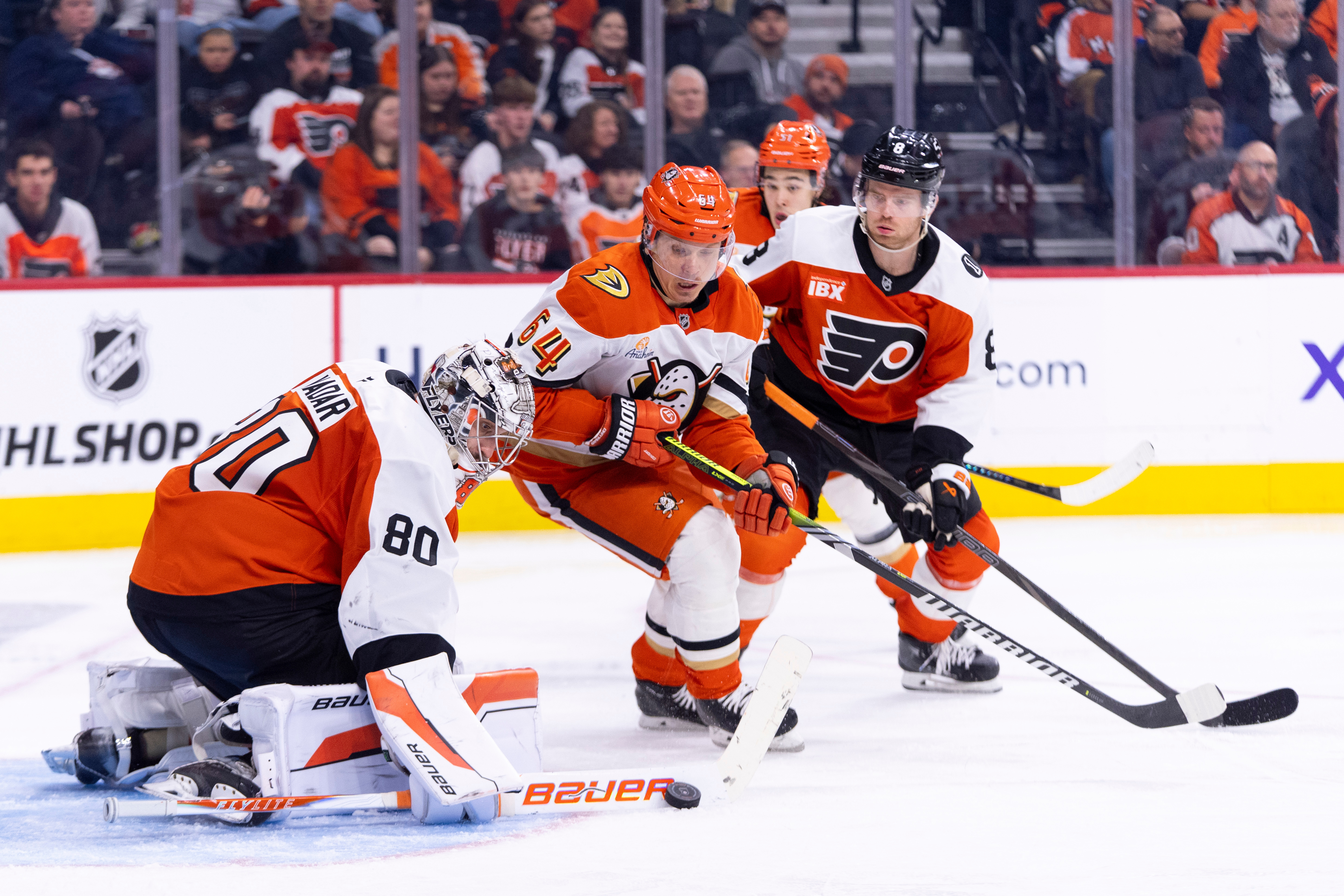 Philadelphia Flyers goaltender Dan Vladar, left, makes the save as...