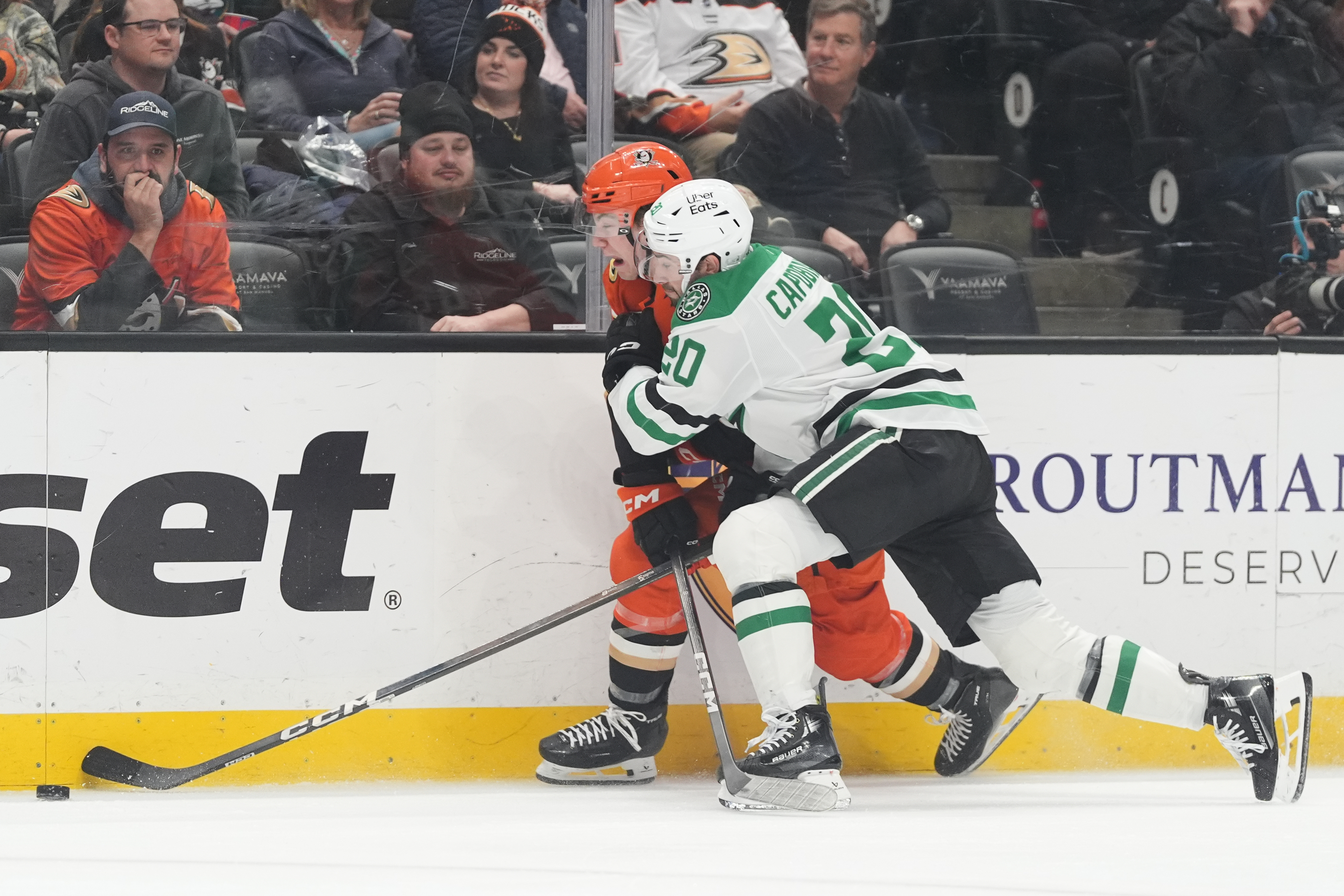 Ducks right wing Beckett Sennecke, left, is hit by Dallas...