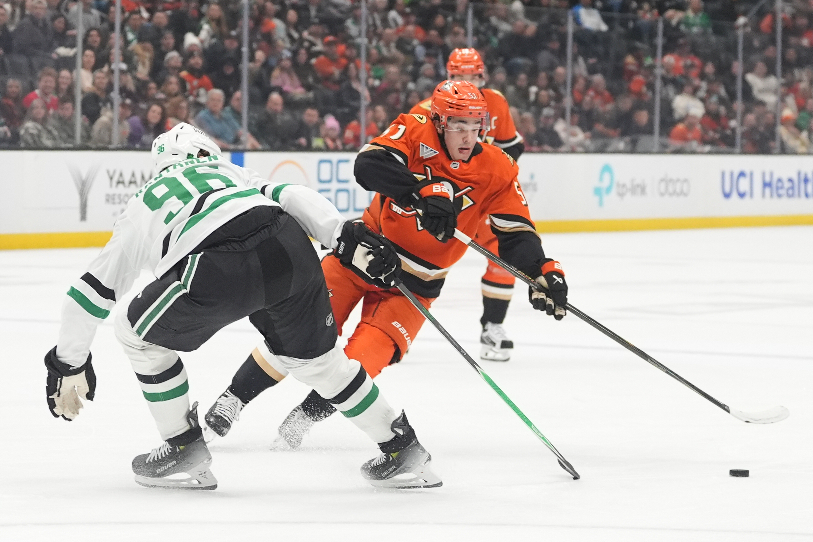Ducks defenseman Olen Zellweger moves the puck up the ice...