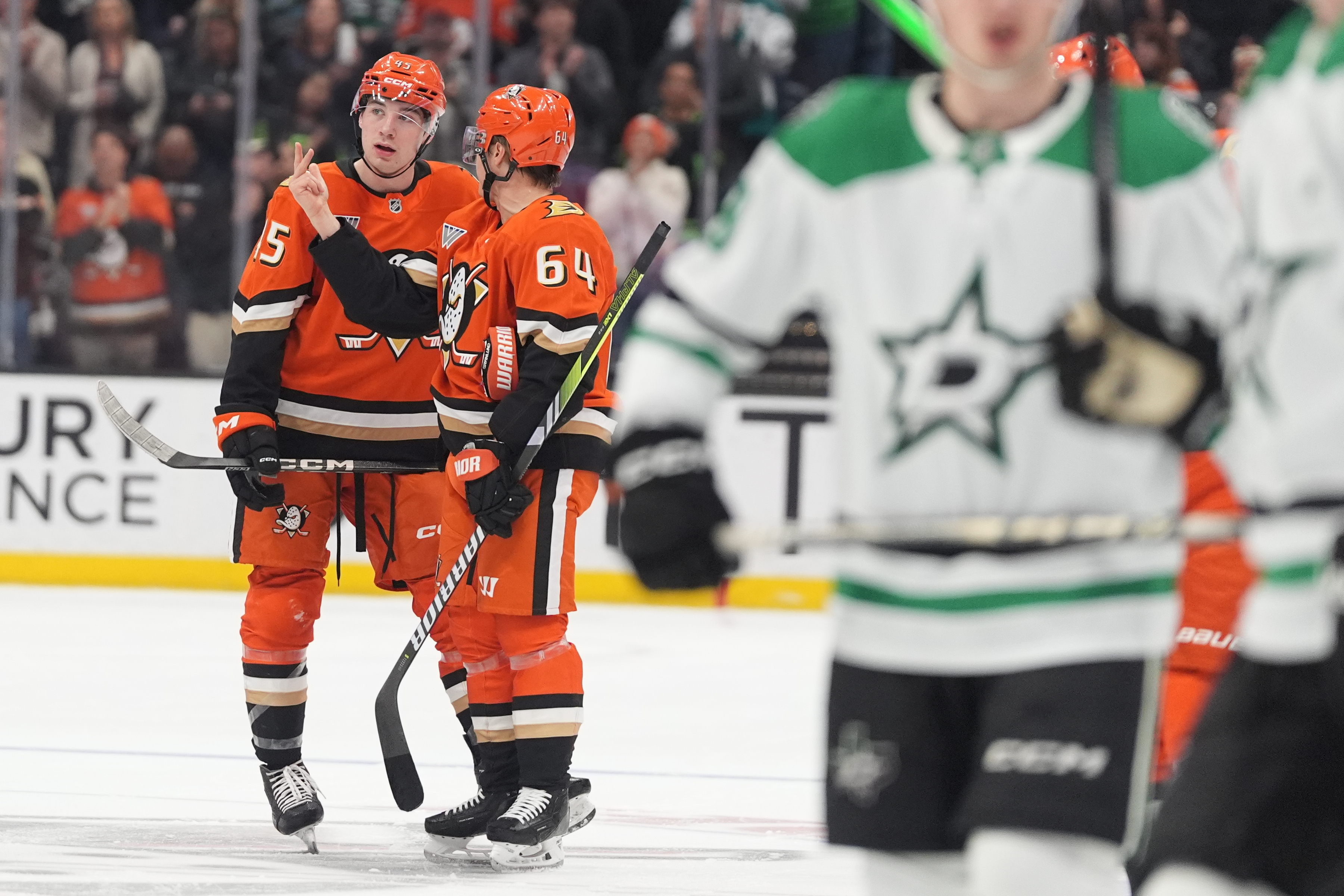 Ducks right wing Beckett Sennecke, left, has a word with...