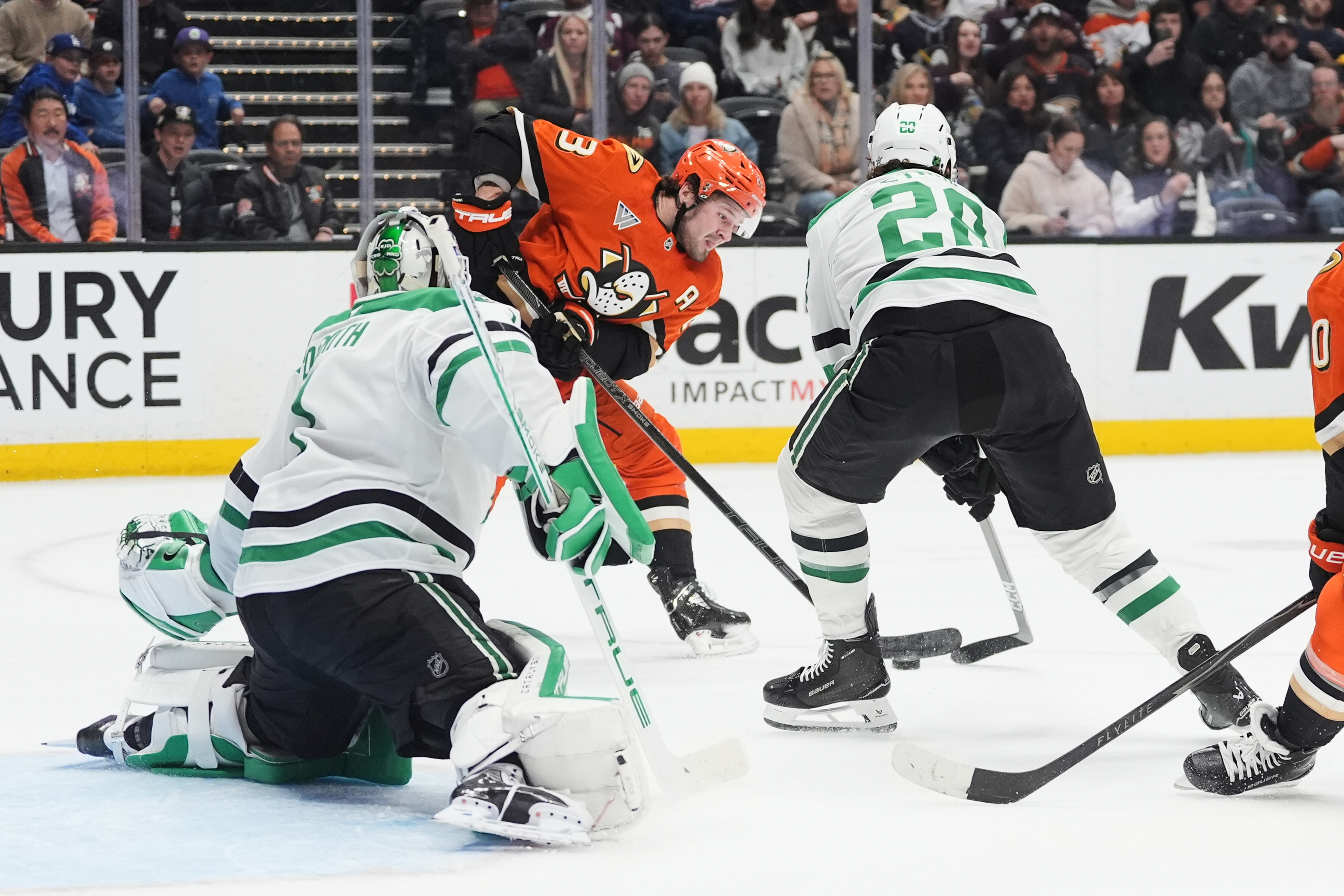 Ducks center Mason McTavish, center, shoots the puck as Dallas...