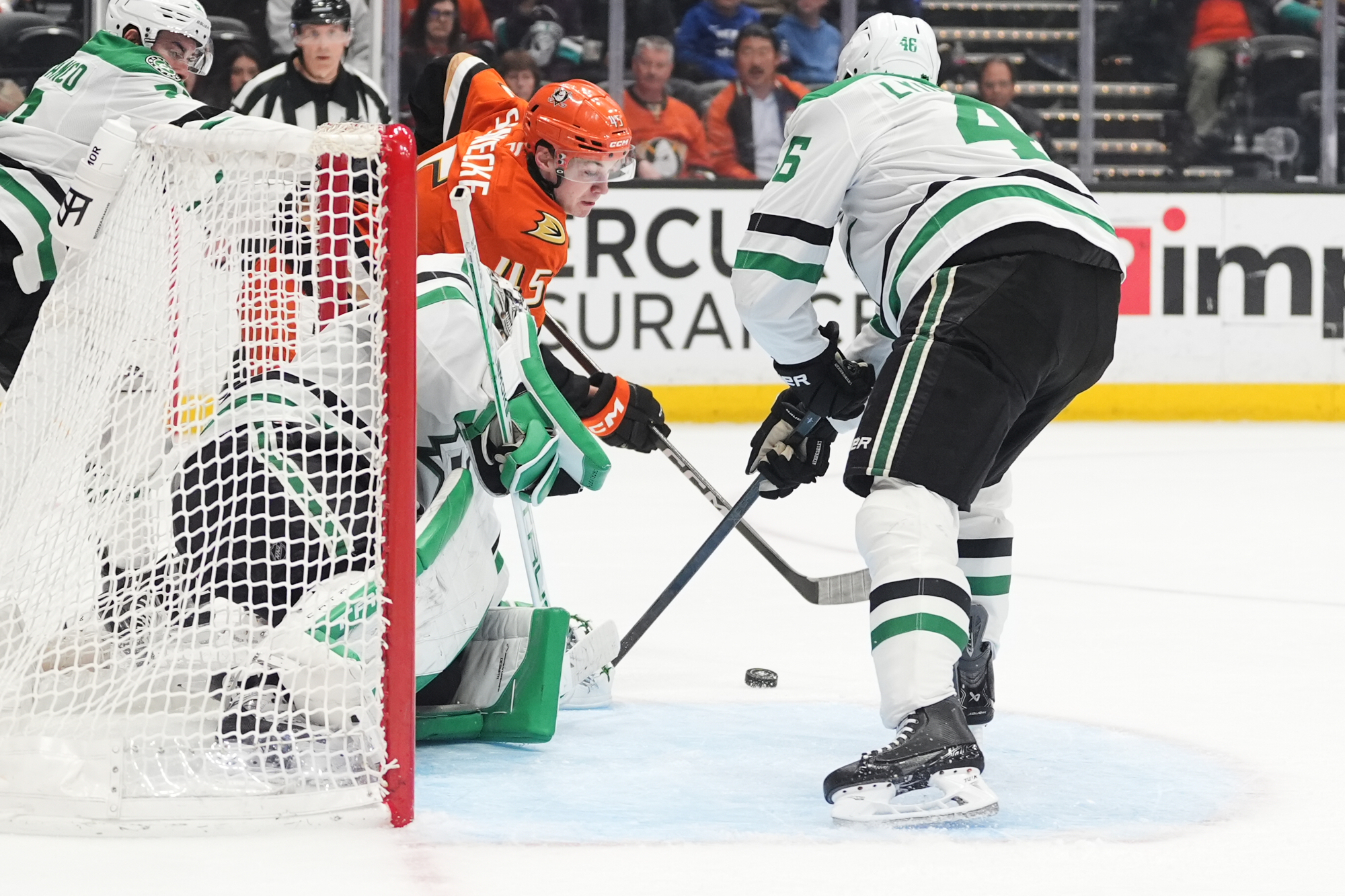 Ducks right wing Beckett Sennecke, behind, scores a goal as...