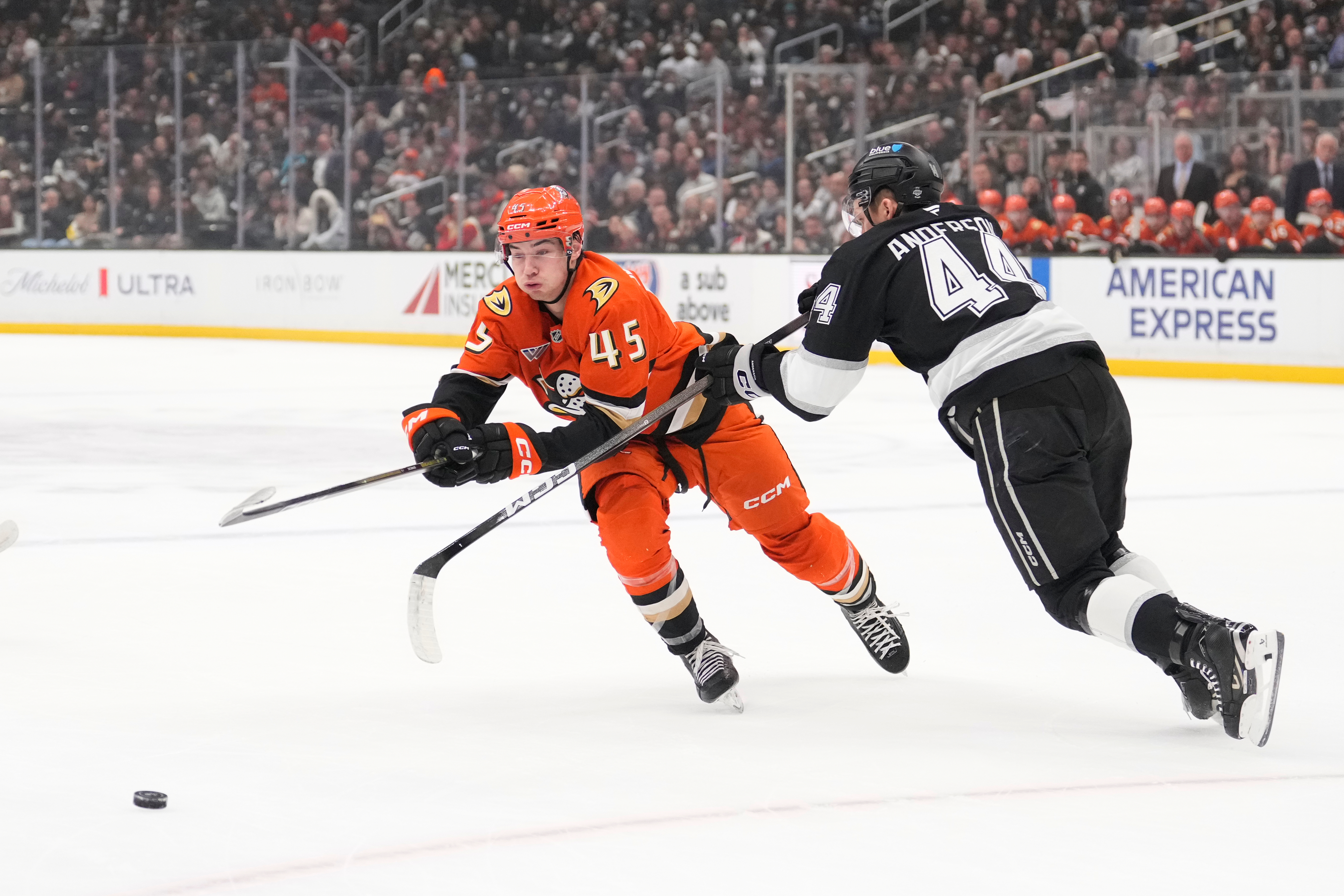 Ducks right wing Beckett Sennecke, left, passes the puck while...
