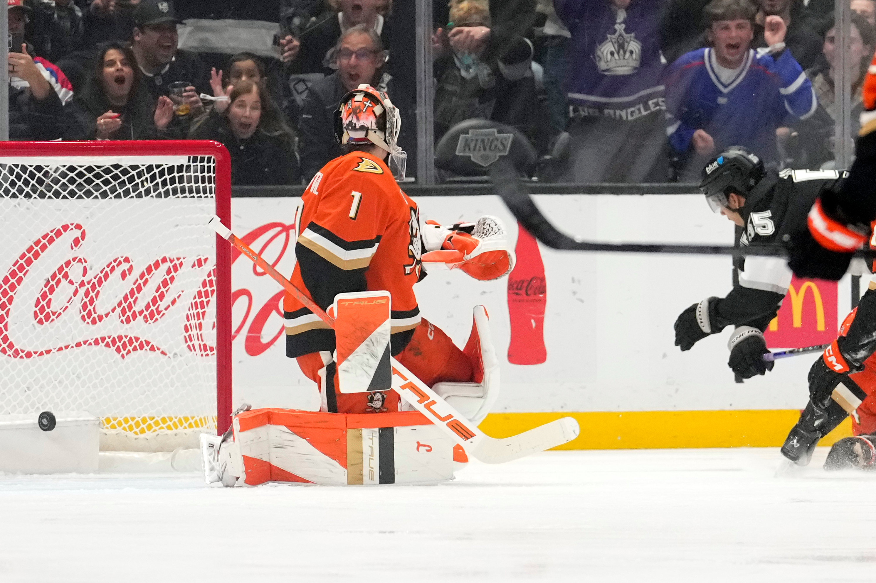 Kings right wing Quinton Byfield, right, scores on Ducks goaltender...