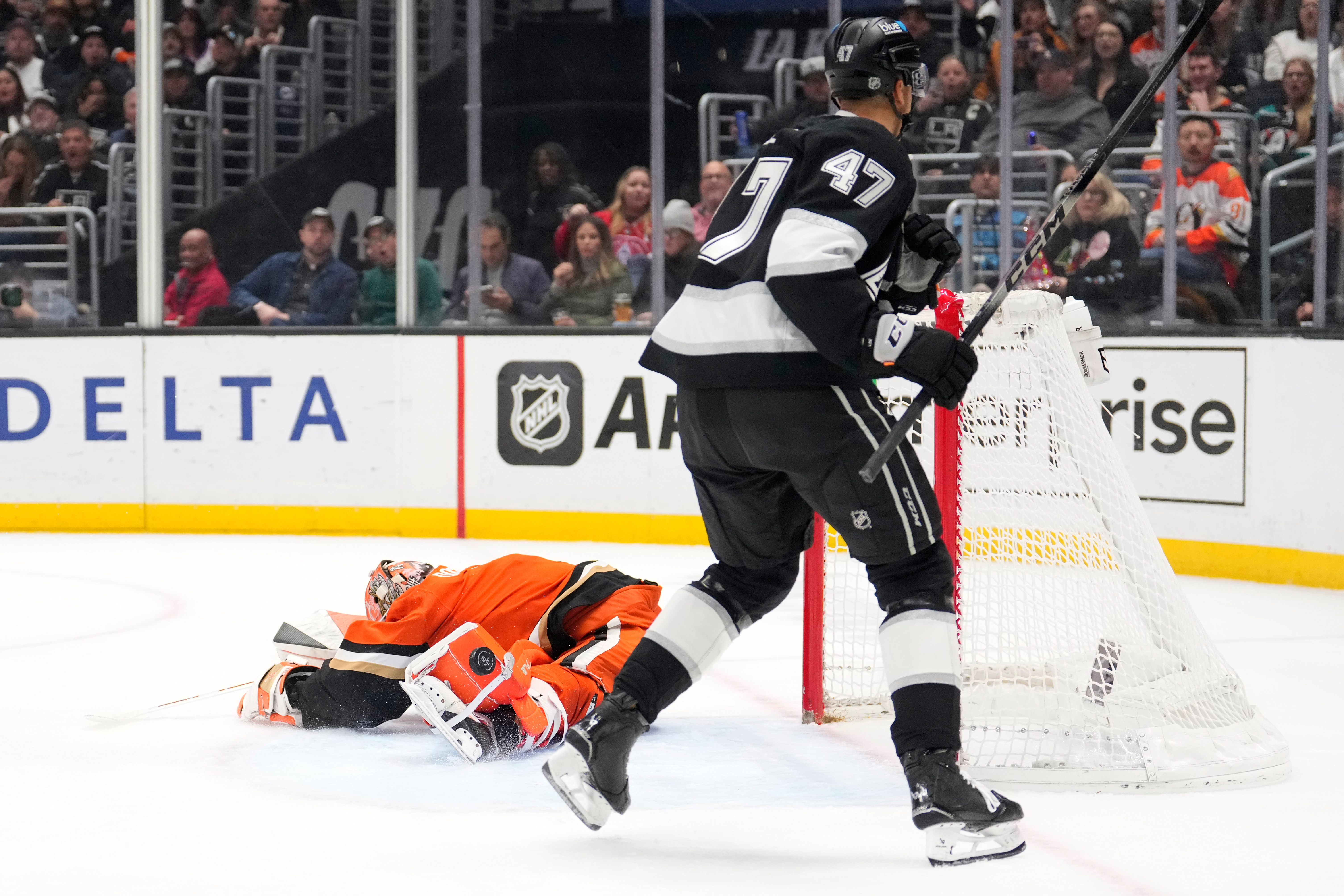 Ducks goaltender Lukas Dostal, left, is scored on by Kings...