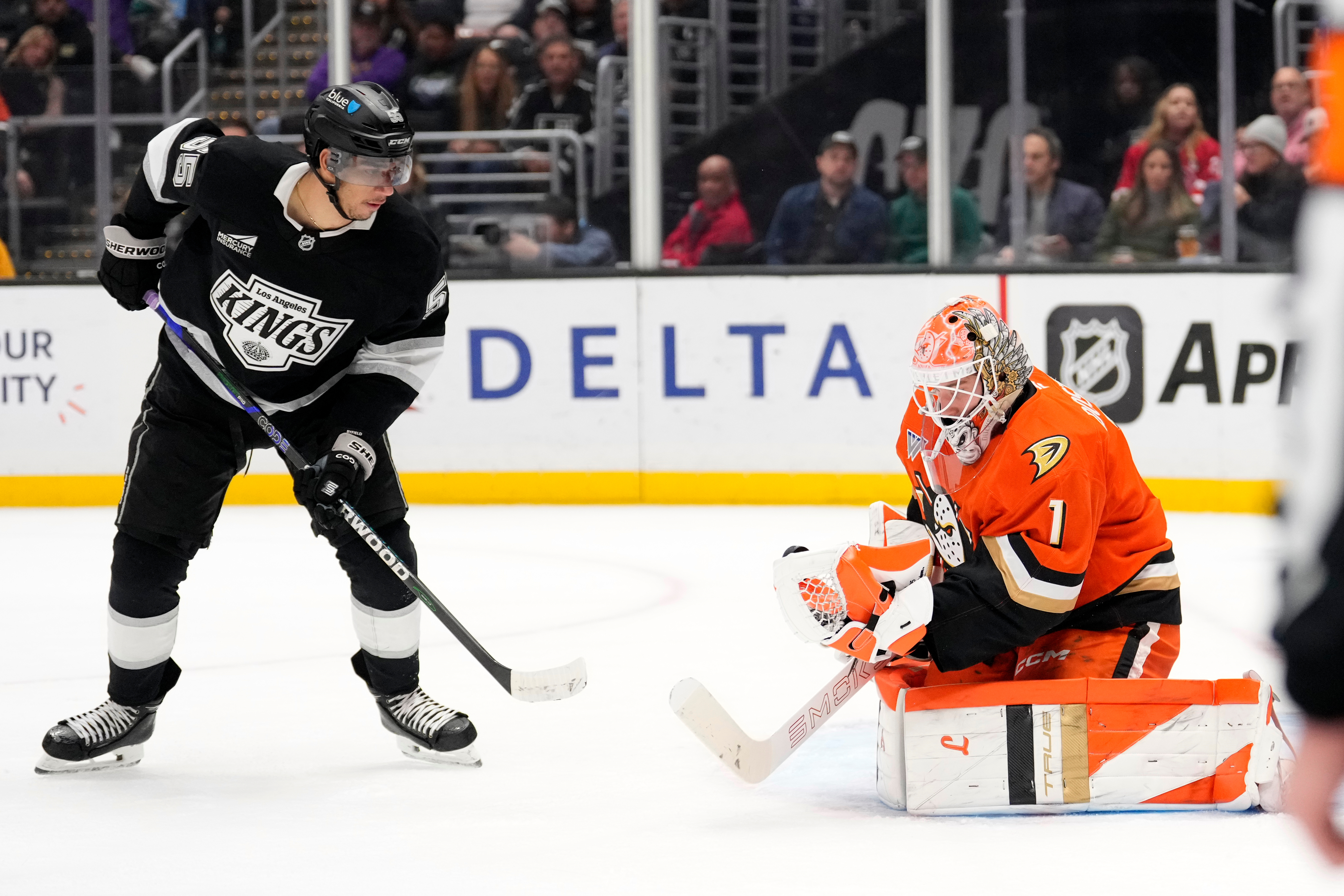 Ducks goaltender Lukas Dostal, right, makes a glove save as...
