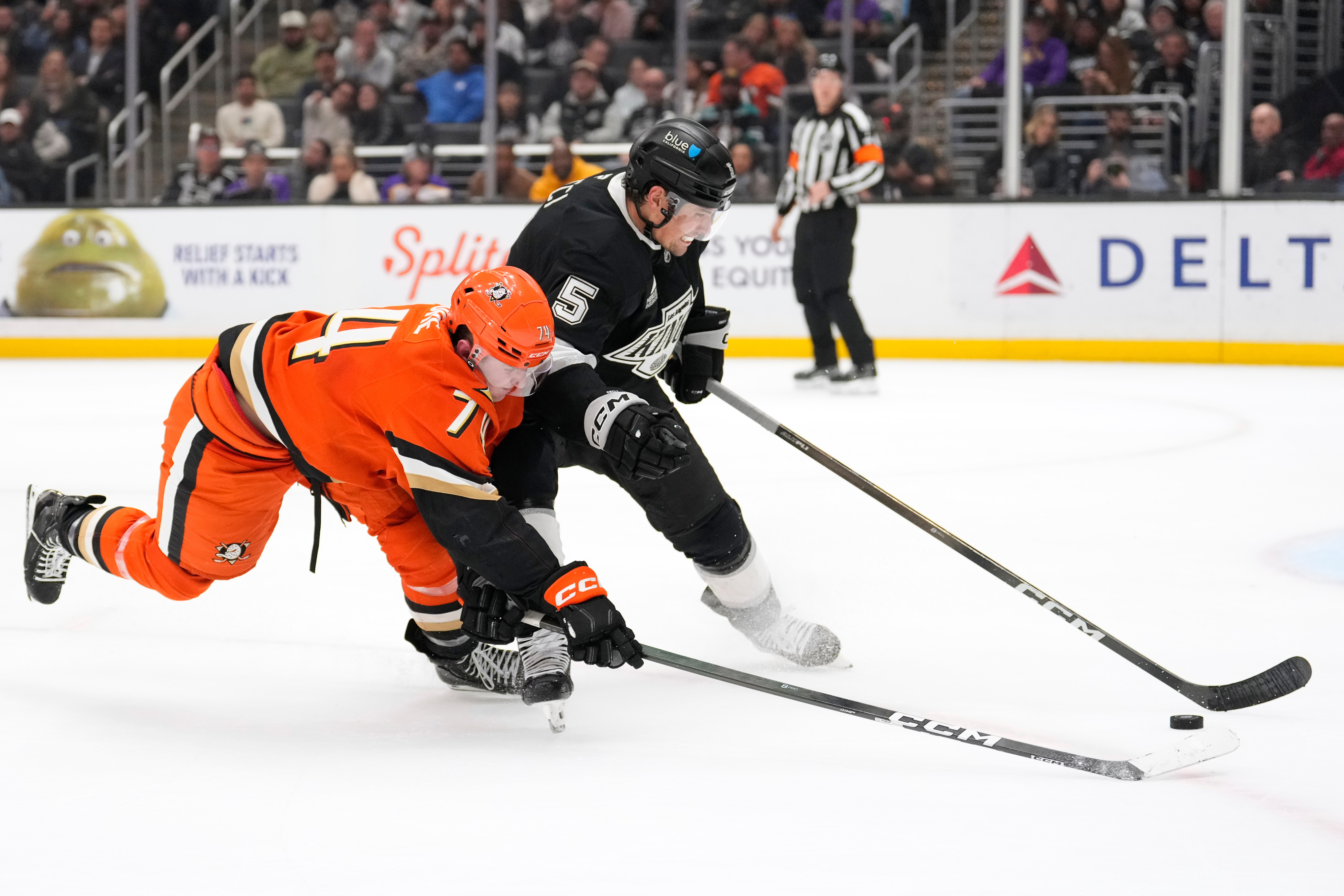 Kings defenseman Cody Ceci, right, and Ducks defenseman Ian Moore...