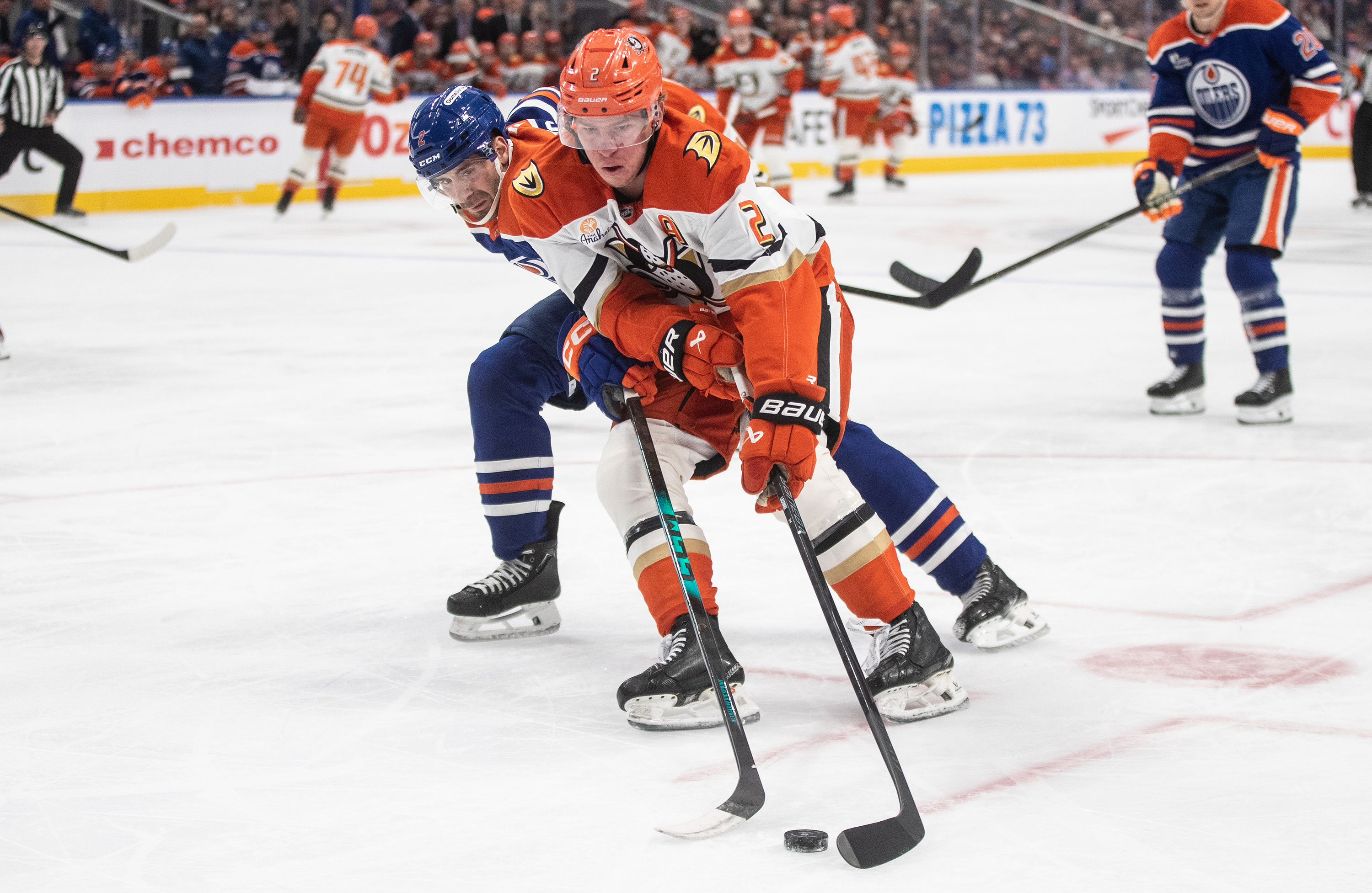 The Ducks’ Jackson LaCombe, center right, and the Edmonton Oilers’...