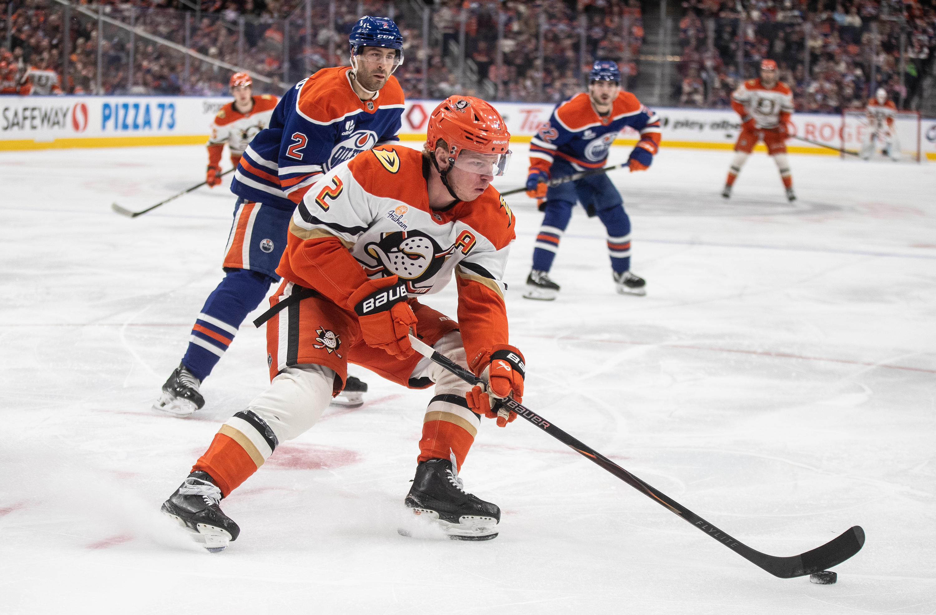 The Ducks’ Jackson LaCombe, front, is chased by the Edmonton...