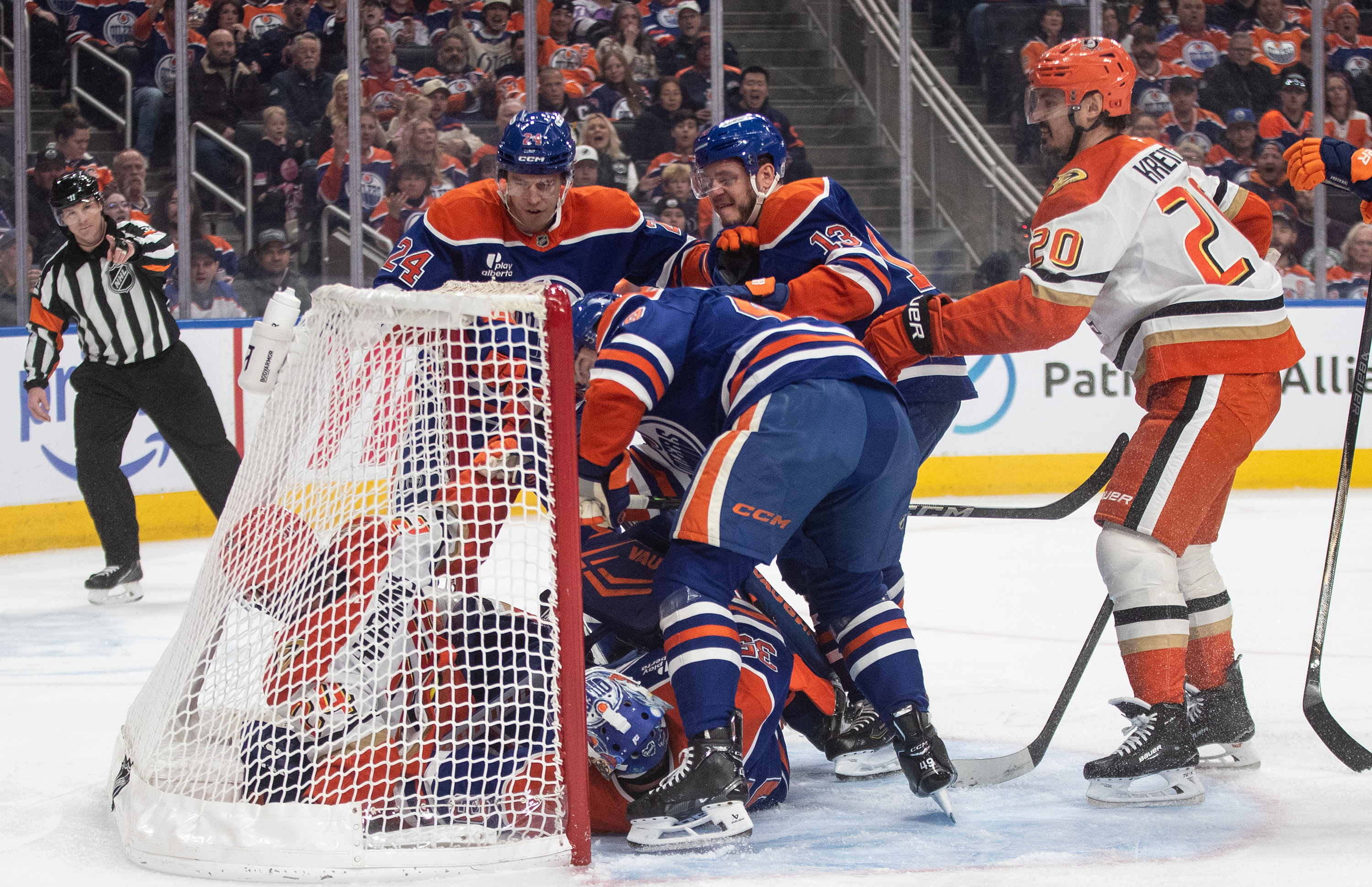 Ducks and Edmonton Oilers players crash the net during the...