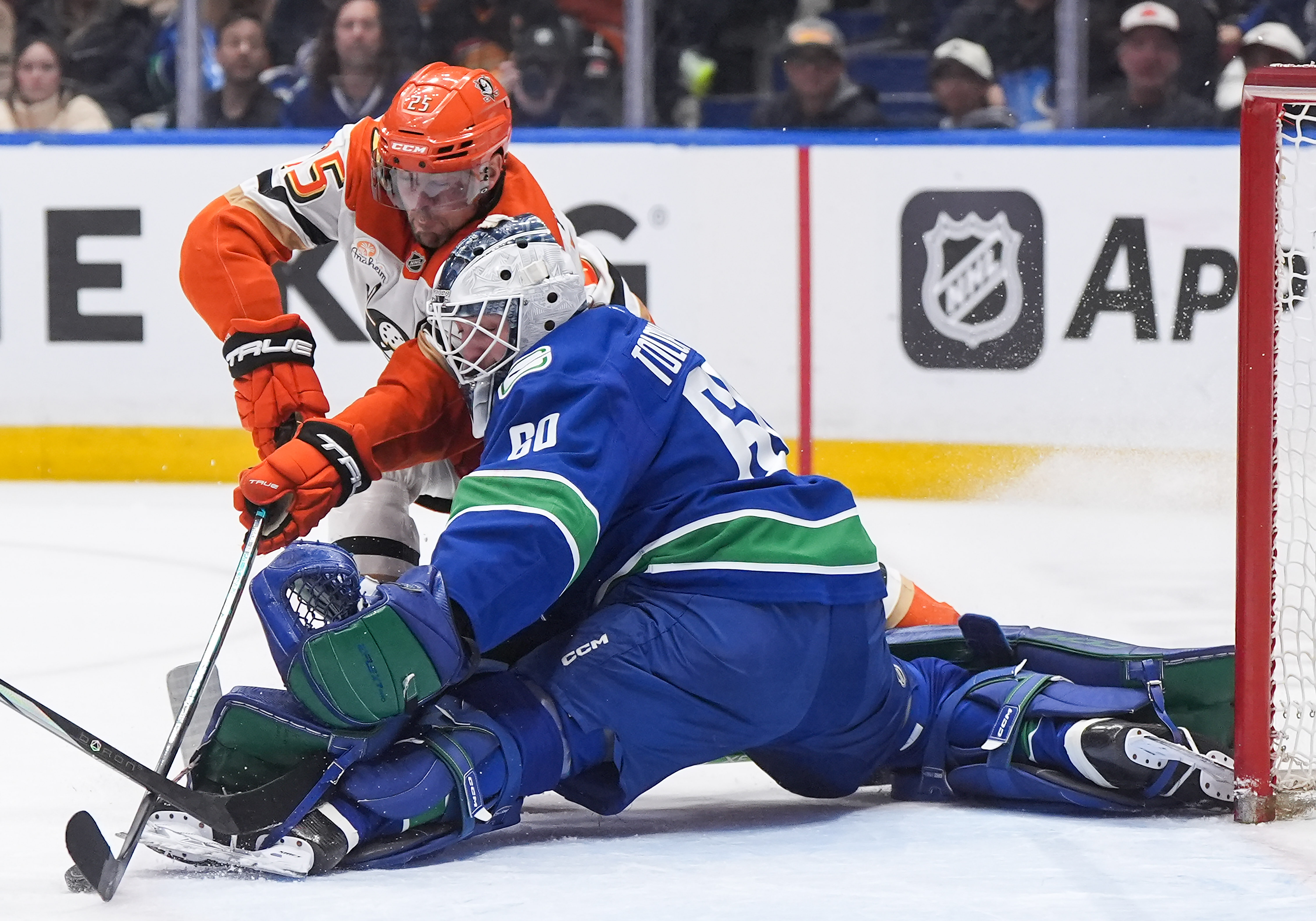 Vancouver Canucks goaltender Nikita Tolopilo, right, stops the Ducks’ Ryan...