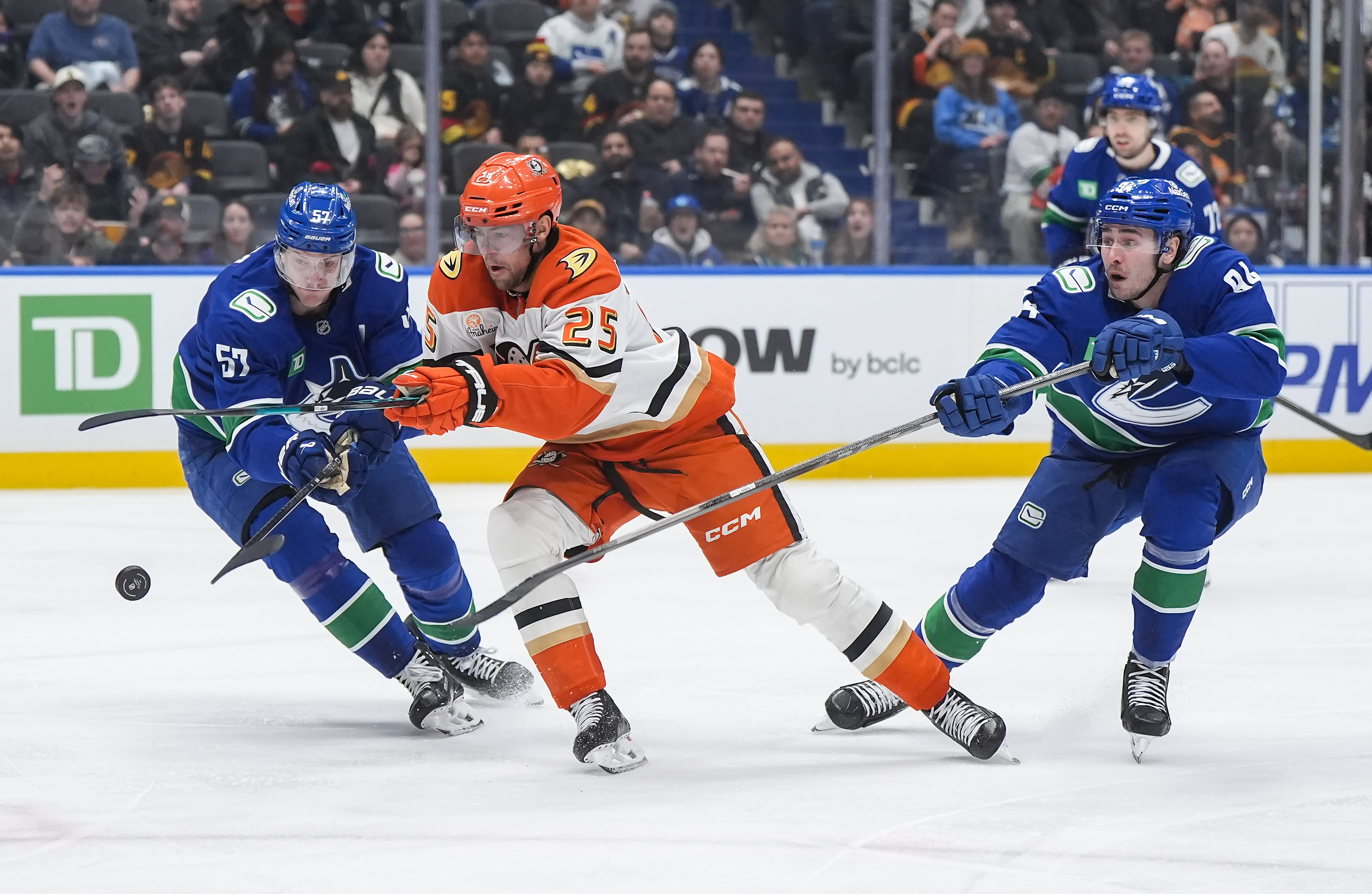 The Vancouver Canucks’ Tyler Myers, left, and the Ducks’ Ryan...