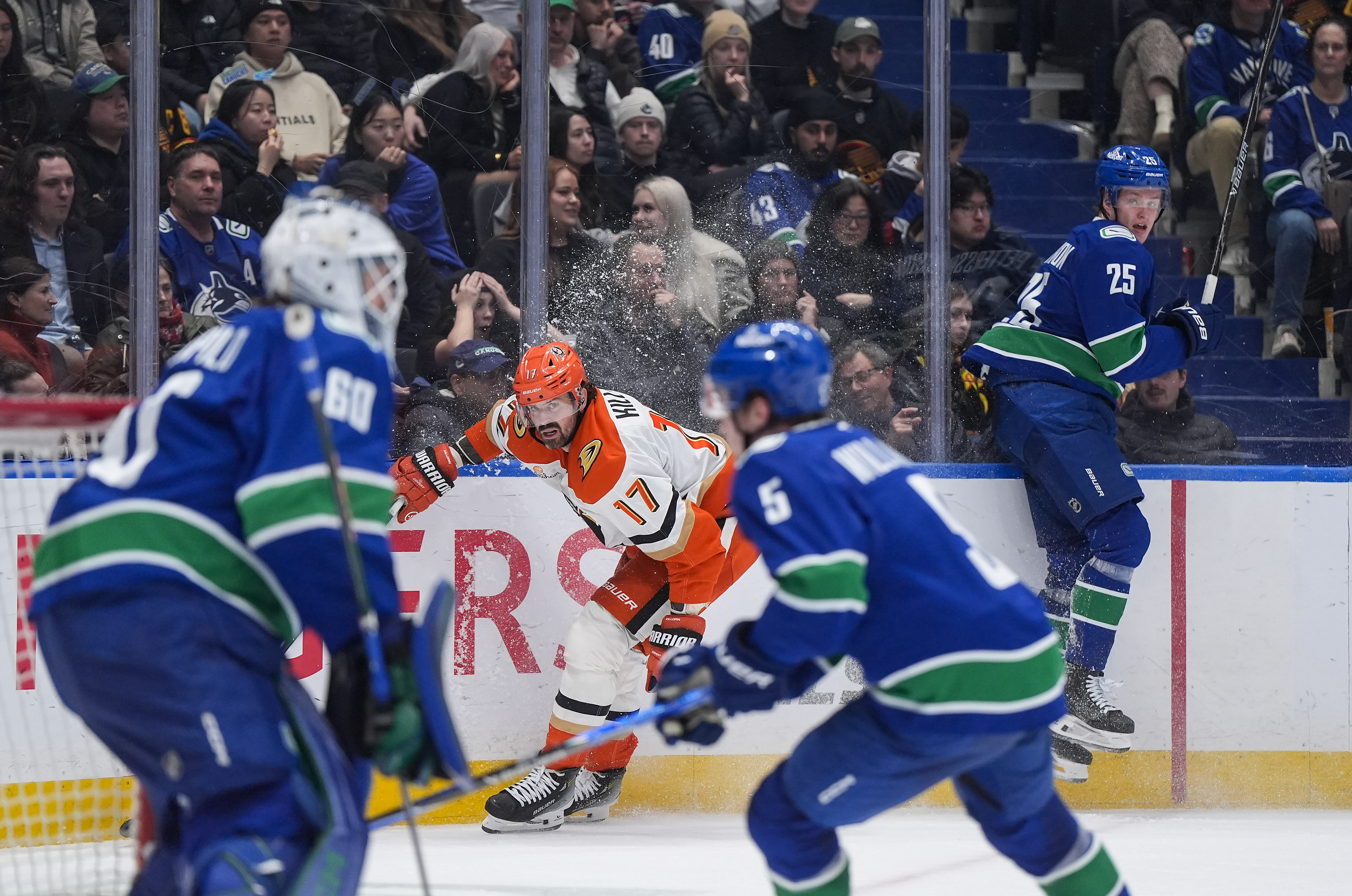 The Vancouver Canucks’ Elias Pettersson (25) avoids a collision with...