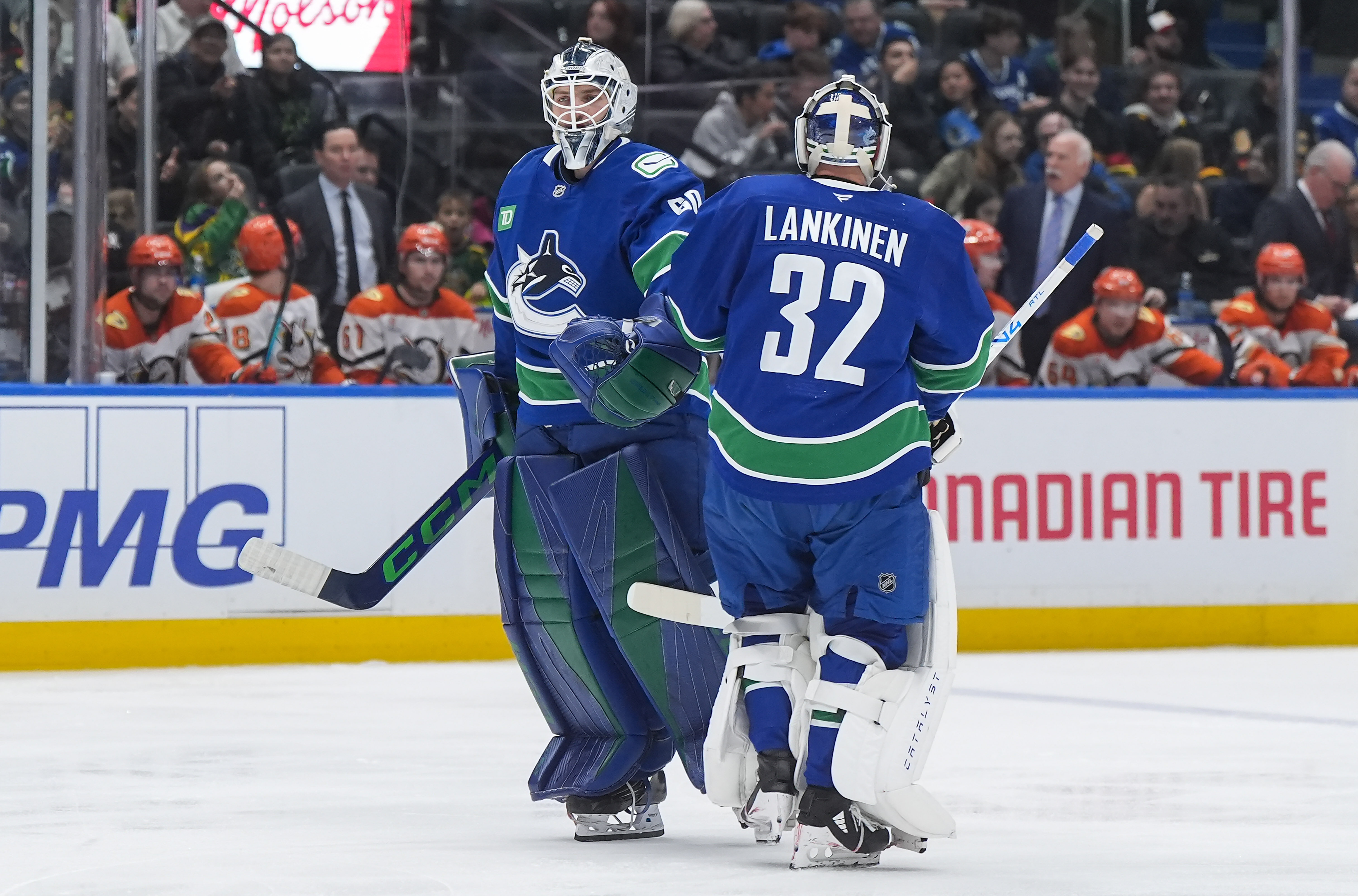 Vancouver Canucks goalie Nikita Tolopilo, left, re-enters the game after...