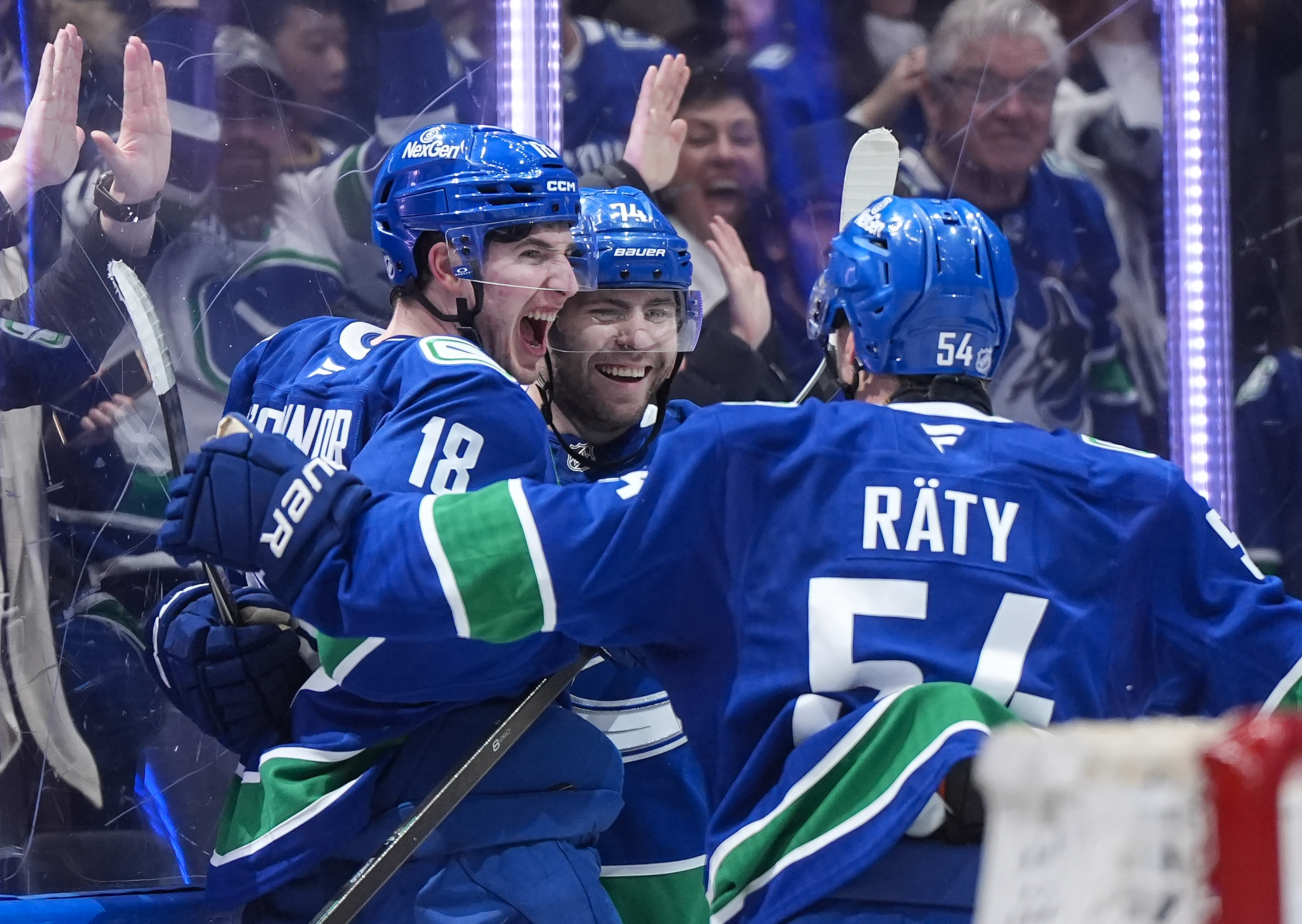 The Vancouver Canucks’ Drew O’Connor (18), Jake DeBrusk (74) and...