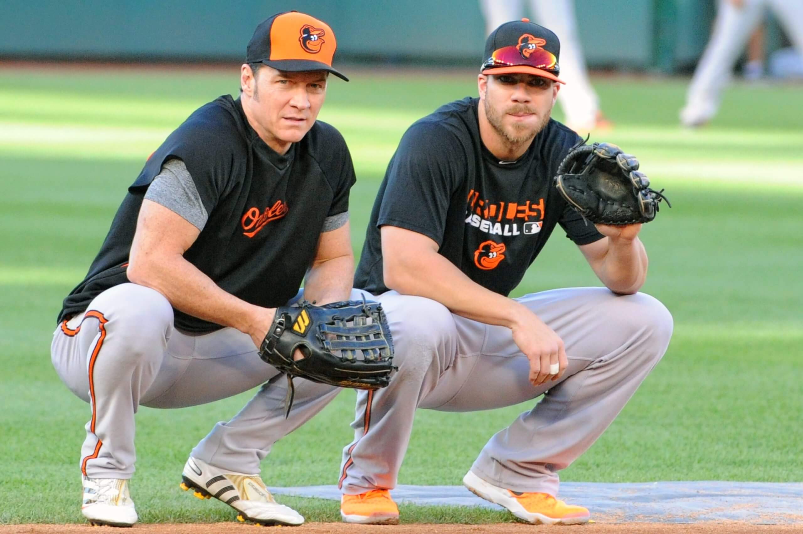 Brady Anderson, left, and Orioles first baseman Chris Davis crouch side by side in the infield in September 2015.