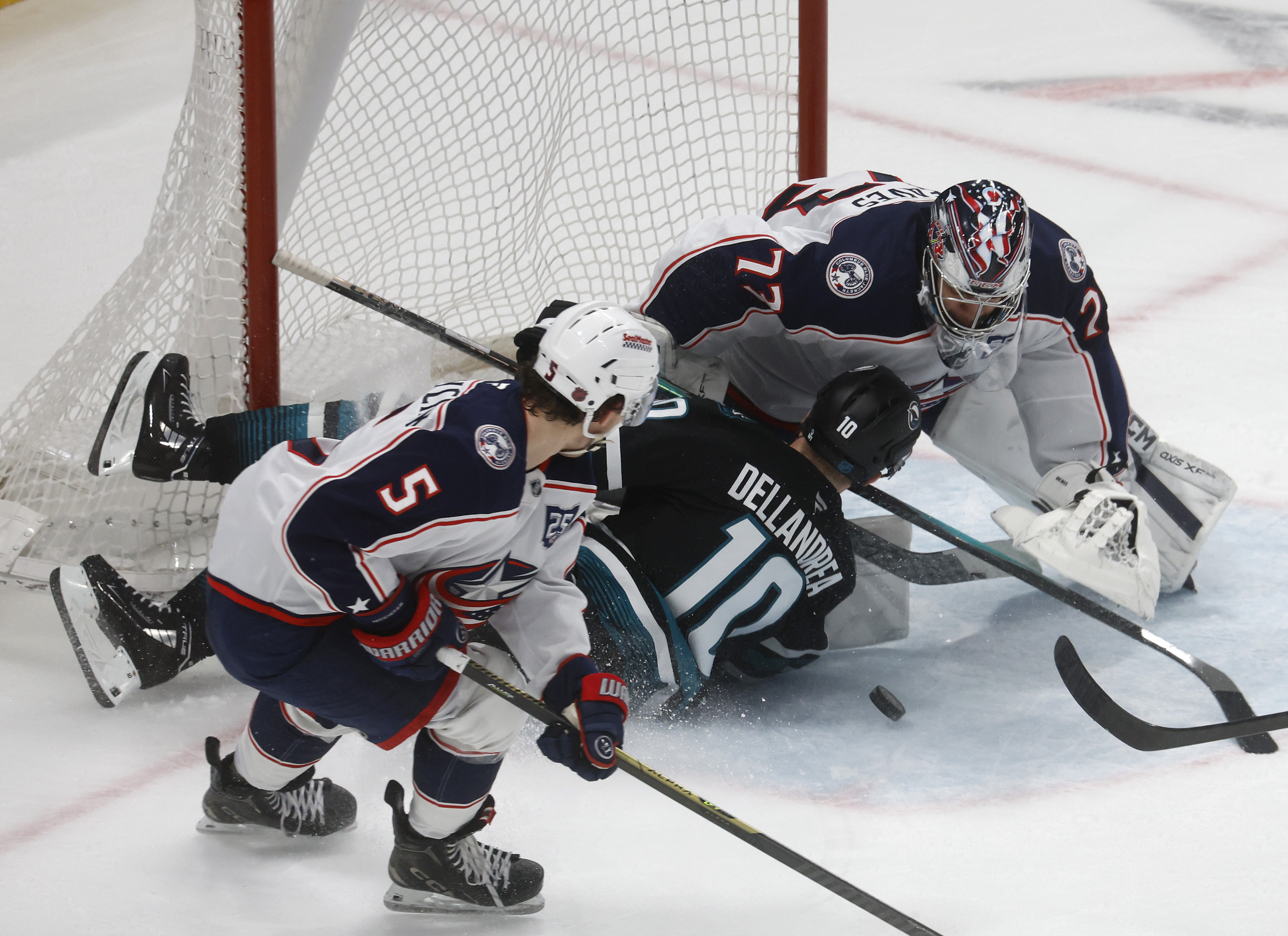 San Jose Sharks' Ty Dellandrea (10) runs into the goal...